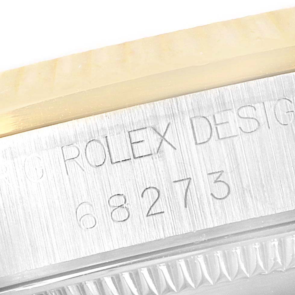 This close-up image shows the case and serial number engraving on the side of a Mid-Size Rolex watch.