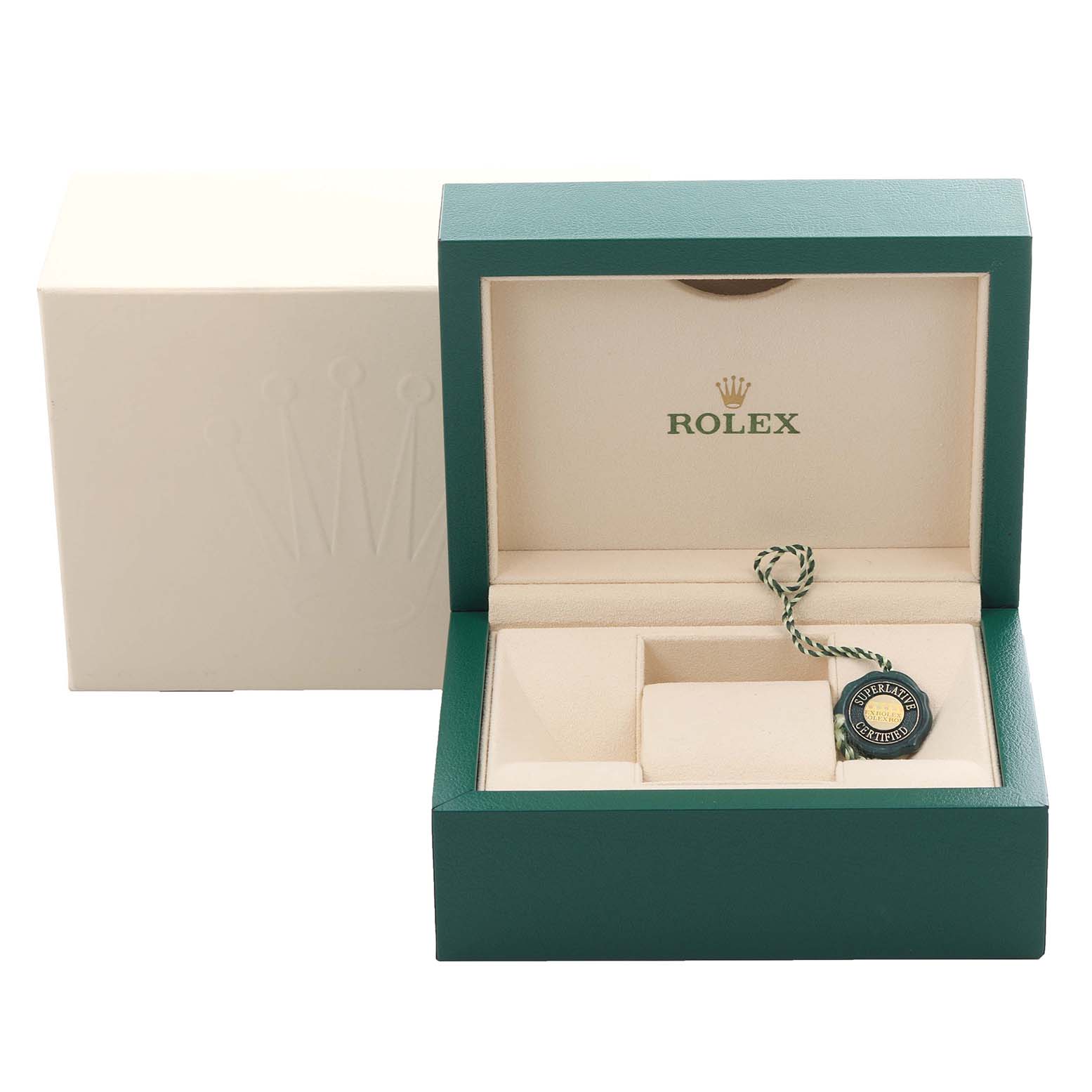 The image shows an open Rolex box with compartments and a green and gold Rolex certified tag, viewed from the front.