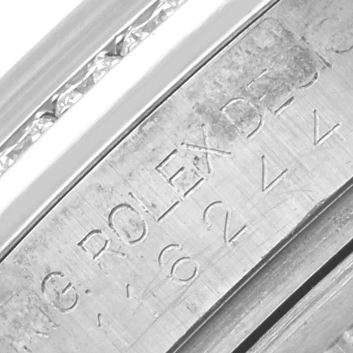 The image shows a close-up of the engraved inner bezel of a Rolex Datejust 116244 Men's Stainless Steel Mother of Pearl Dial 116244 Men's Stainless Steel Mother of Pearl Dial.