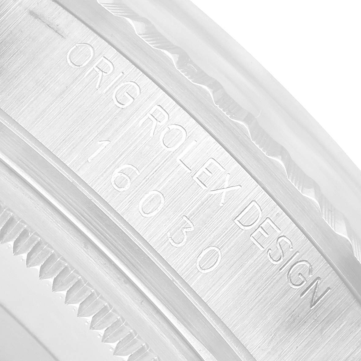 The image shows a close-up of the Rolex Datejust 16030 Men's Stainless Steel Silver Dial's inner bezel engraving with the design and model number visible.