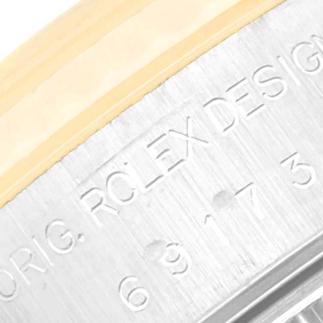 This image shows a close-up of the engraved side of a Rolex Datejust 69173 Women's Steel and Gold (two tone) Silver Dial 69173 Women's Steel and Gold (two tone) Silver Dial watch case, highlighting some of the branding details.