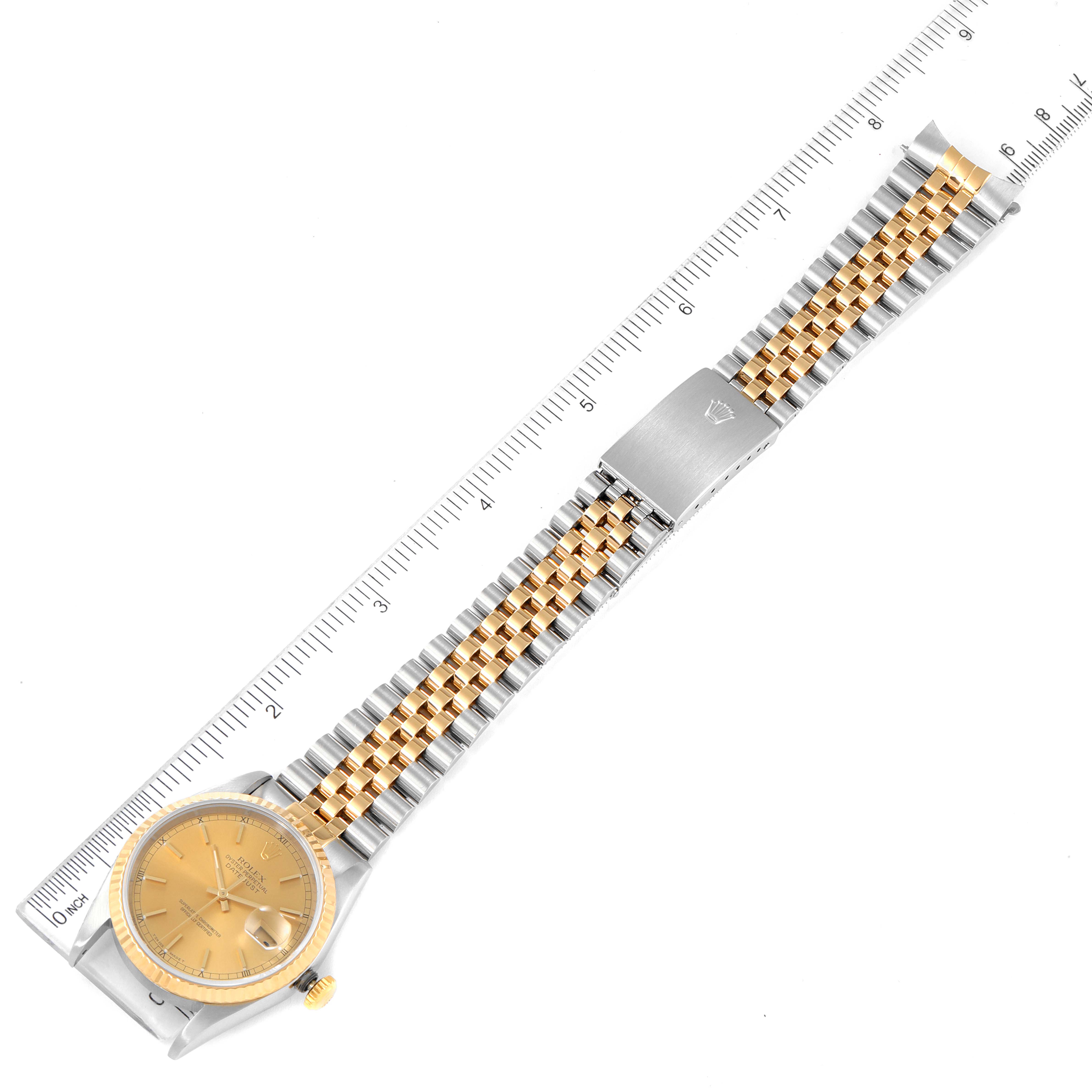 The image shows a Rolex Datejust 16233 Men's Steel and Gold (two tone) Champagne Dial 16233 Men's Steel and Gold (two tone) Champagne Dial watch, viewed from the top, highlighting the dial, bezel, and jubilee bracelet with a ruler for scale.