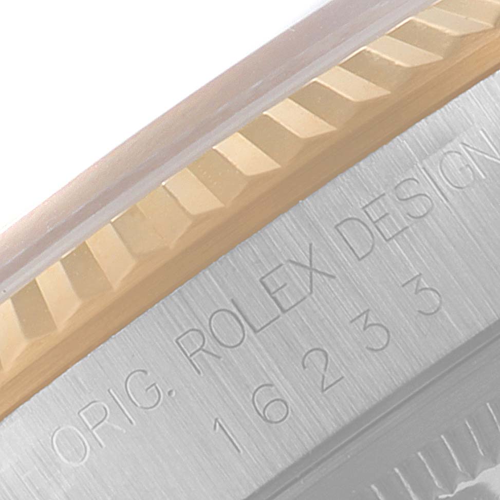 This image shows a close-up angle of the bezel and engraved case side of a Rolex Datejust 16233 Men's Steel and Gold (two tone) Champagne Dial 16233 Men's Steel and Gold (two tone) Champagne Dial watch.