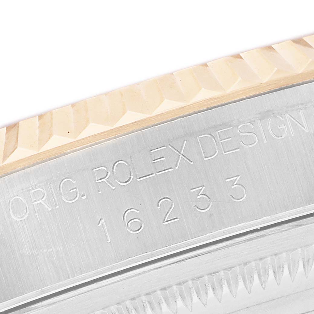 The image shows a close-up of the Rolex Datejust 16233 Men's Steel and Gold (two tone) White Dial model's case side, highlighting the fluted bezel and engravings.
