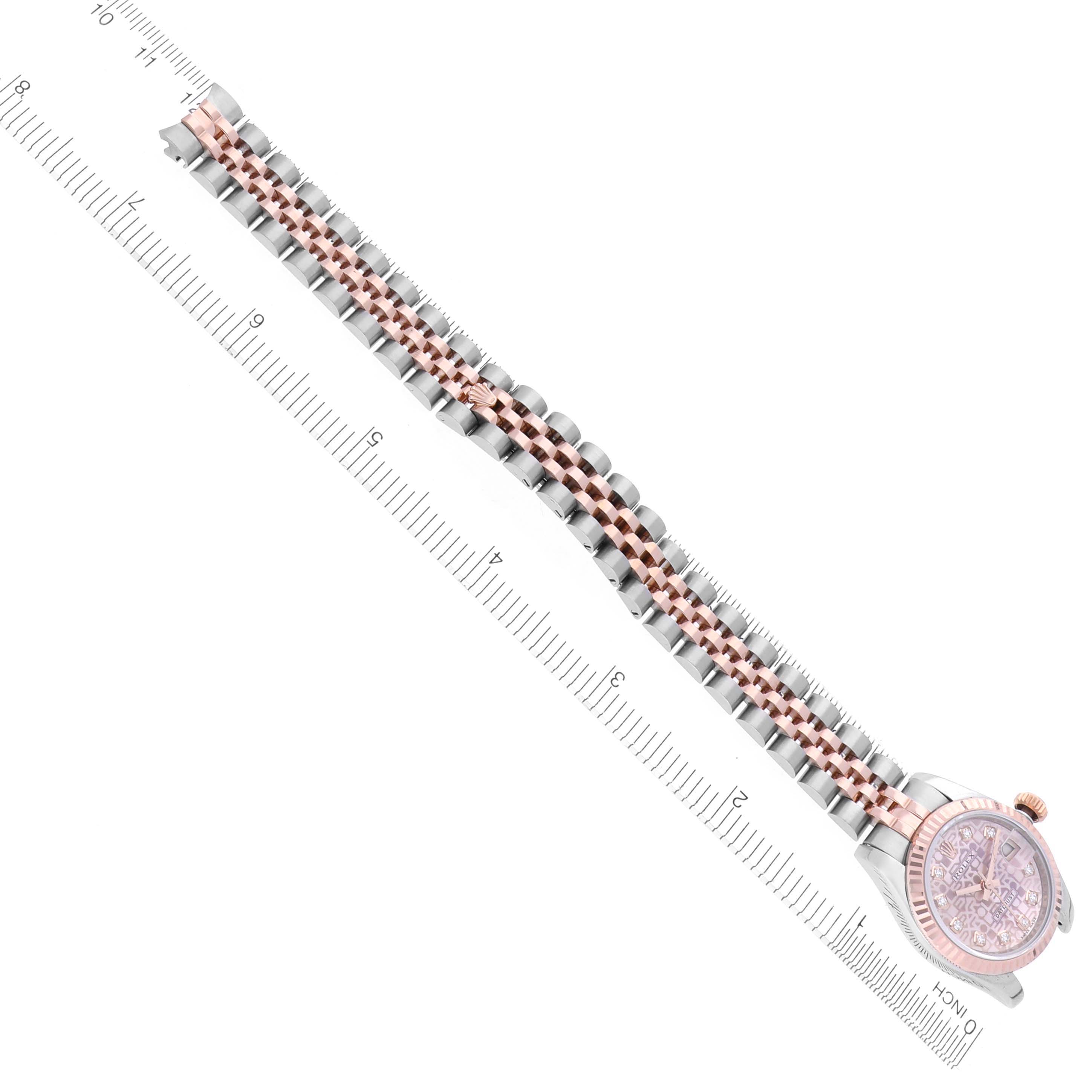 The image shows the Rolex Datejust 179171 Women's Steel and Gold (two tone) Pink Dial 179171 Women's Steel and Gold (two tone) Pink Dial watch from a top view, highlighting the bracelet and part of the face alongside a ruler.