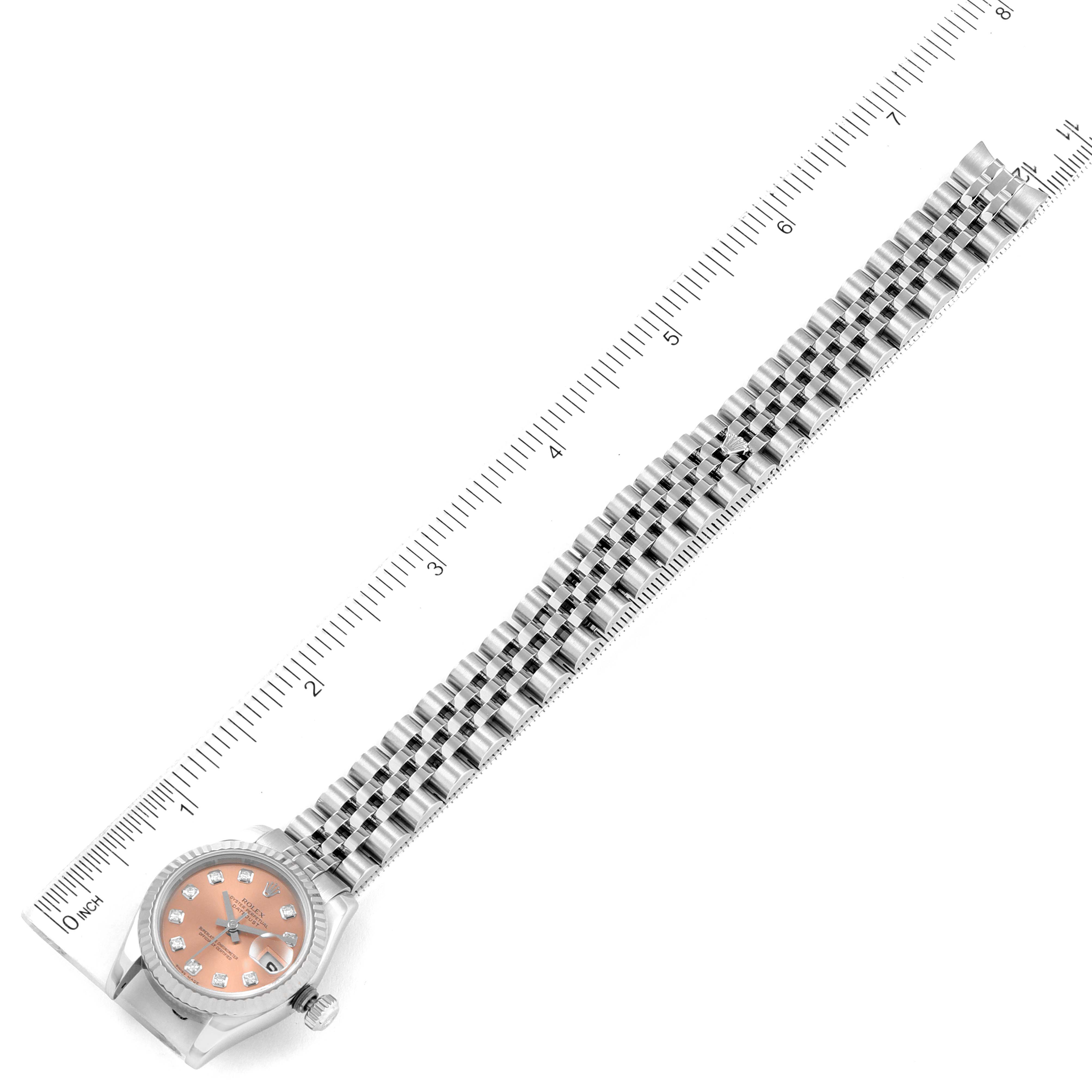 This image shows a top view of a Rolex Datejust 179174 Women's Stainless Steel Pink Dial 179174 Women's Stainless Steel Pink Dial watch, displaying the dial, bezel, and full bracelet alongside a measurement ruler.