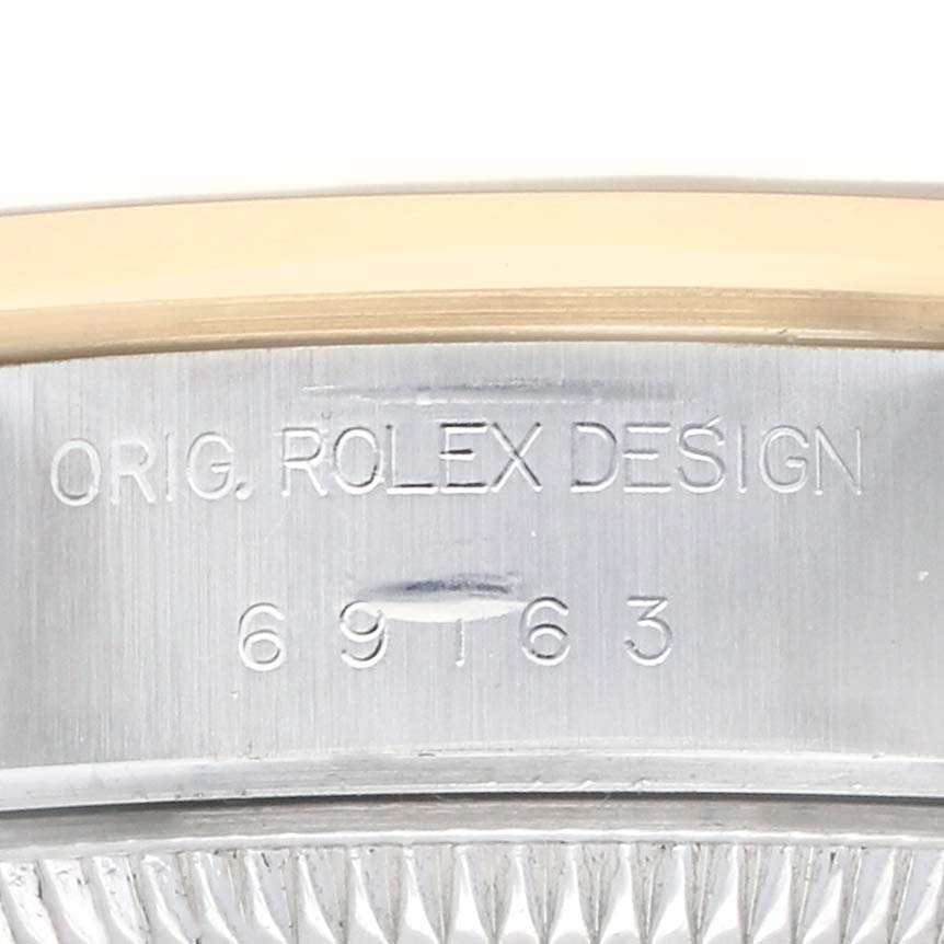 The image shows a close-up of the side of a Rolex Datejust 69163 Women's Steel and Gold (two tone) Black Dial case, highlighting the "ORIG. ROLEX DESIGN" engraving with the model number.