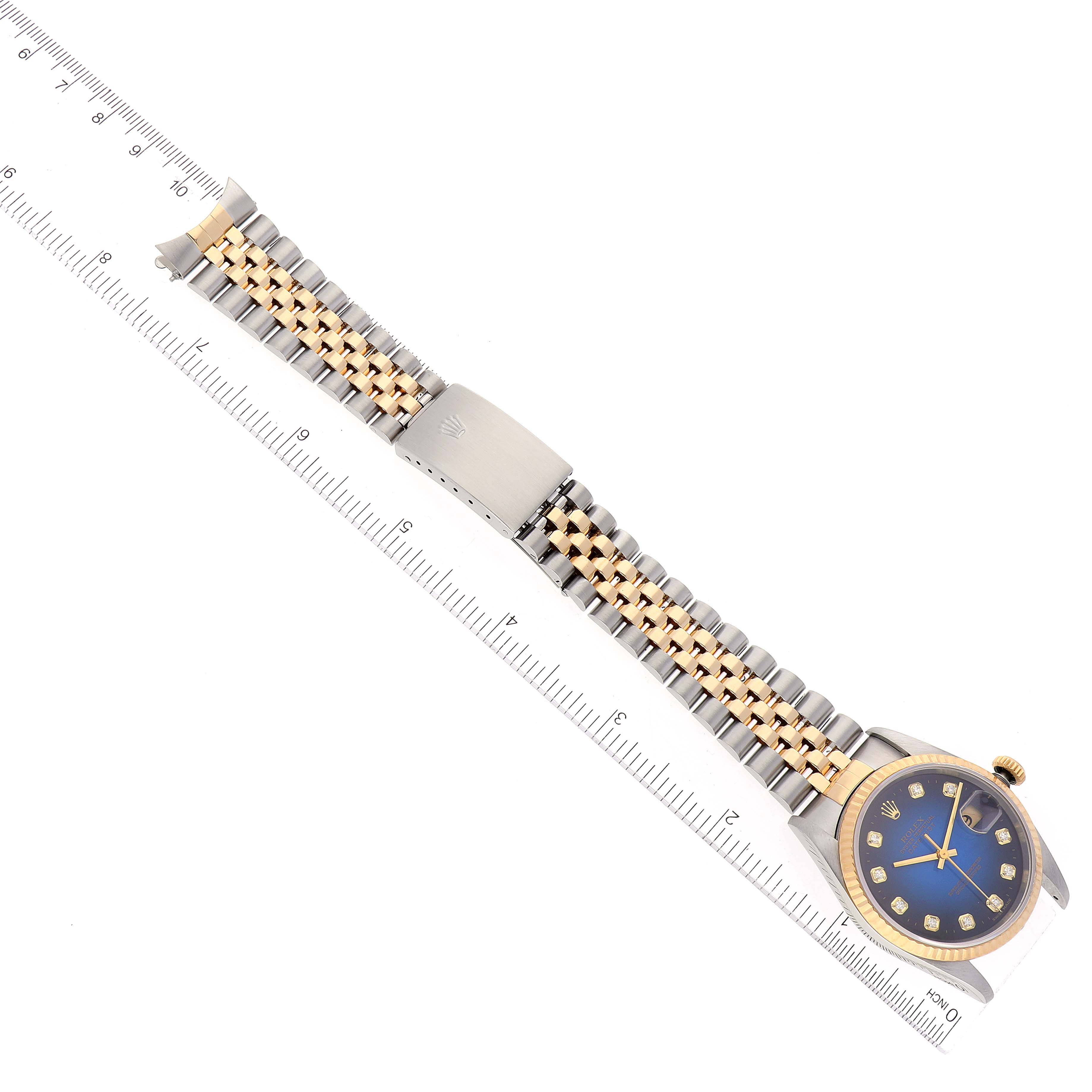 The image shows a Rolex Datejust 16233 Men's Steel and Gold (two tone) Blue Dial 16233 Men's Steel and Gold (two tone) Blue Dial watch, showcasing the full bracelet and face, aligned cleanly with a ruler for scale.