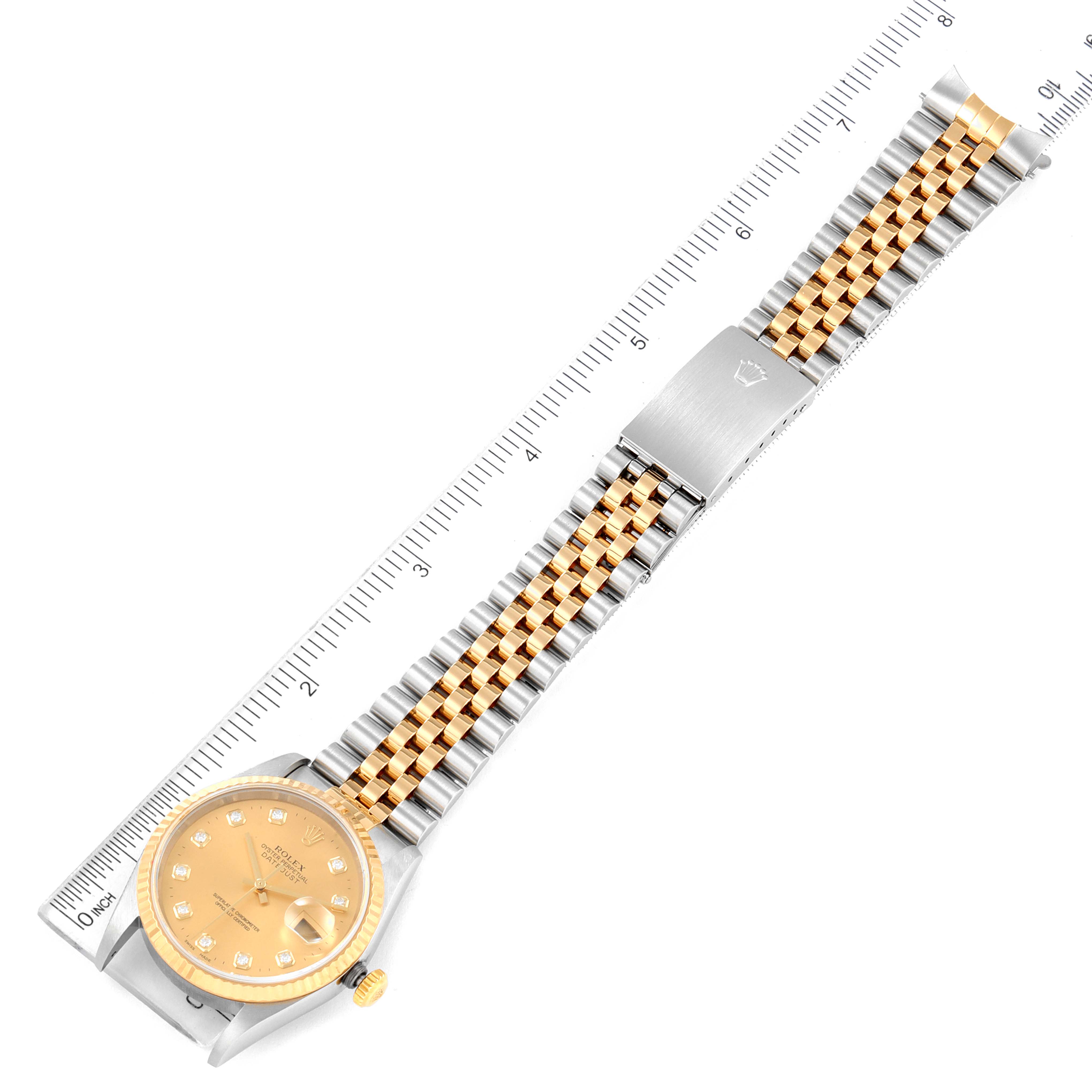 This image shows a top-down view of a Rolex Datejust 16233 Men's Steel and Gold (two tone) Champagne Dial 16233 Men's Steel and Gold (two tone) Champagne Dial watch, featuring its dial, crown, and Jubilee bracelet with a ruler for scale.