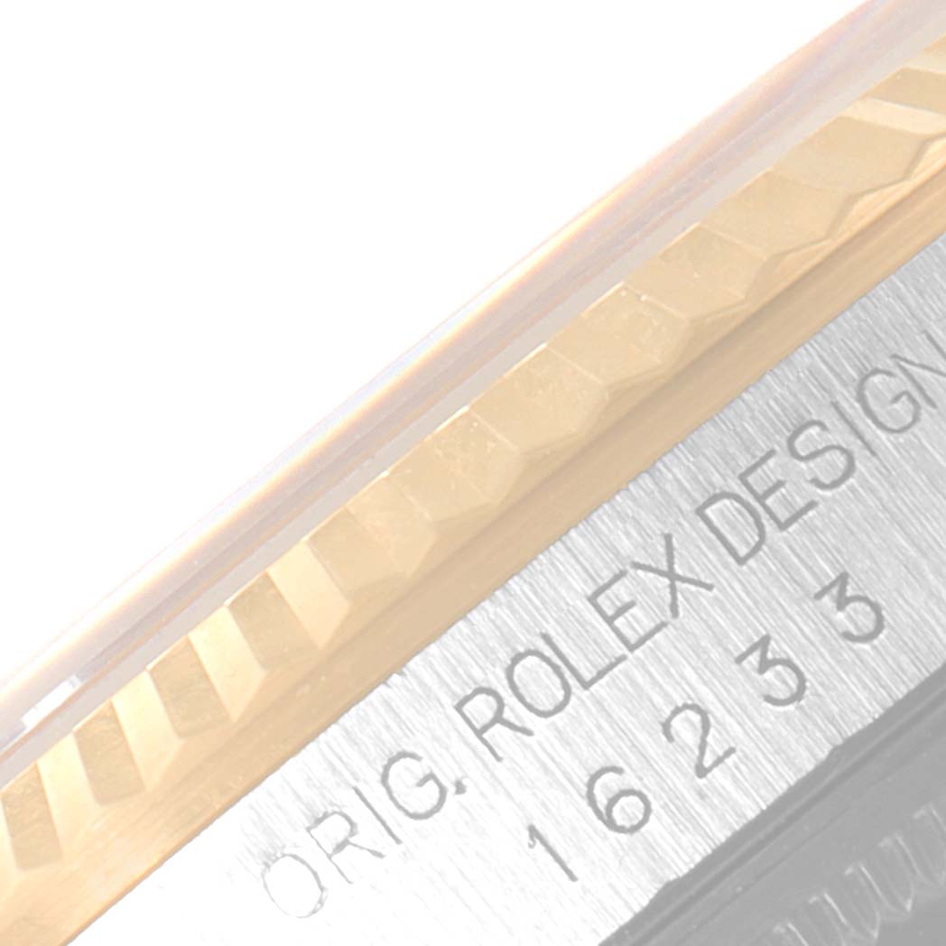 The image shows a close-up of the side of a Rolex Datejust 16233 Men's Steel and Gold (two tone) Champagne Dial 16233 Men's Steel and Gold (two tone) Champagne Dial watch, highlighting the fluted bezel and engraved model details.
