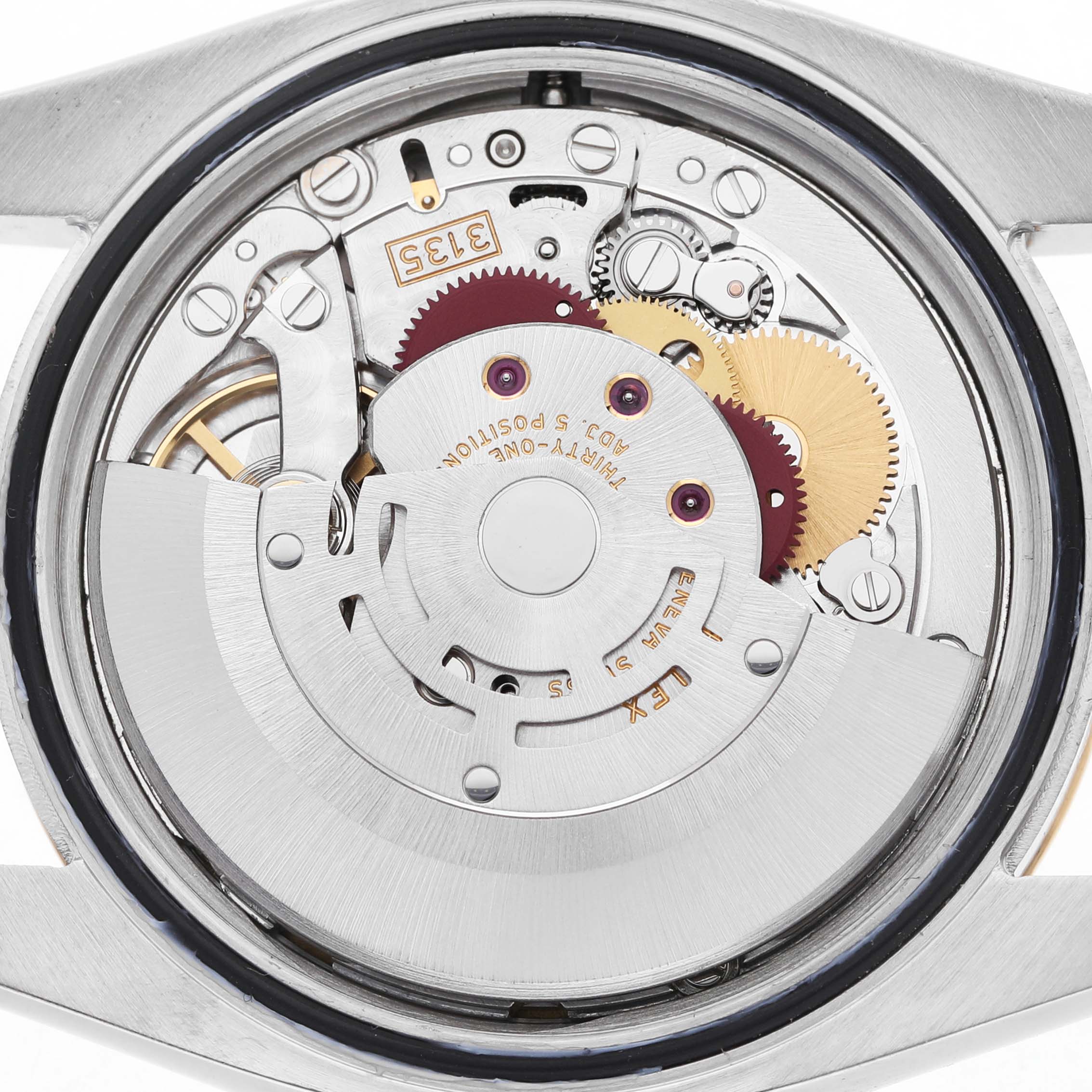 The image shows the movement of a Rolex Datejust 116203 Men's Steel and Gold (two tone) Mother of Pearl Dial watch from a rear view, highlighting gears and mechanical components.