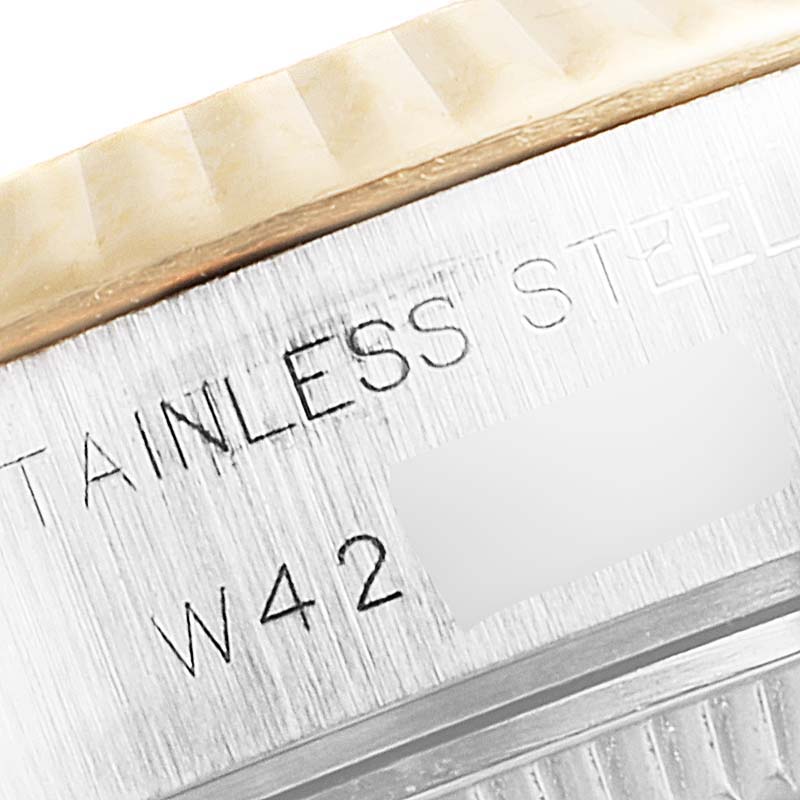 This image shows a close-up of the bezel and case back of a Rolex Datejust 69173 Women's Steel and Gold (two tone) Silver Dial 69173 Women's Steel and Gold (two tone) Silver Dial watch, highlighting the "STAINLESS STEEL" engraving.