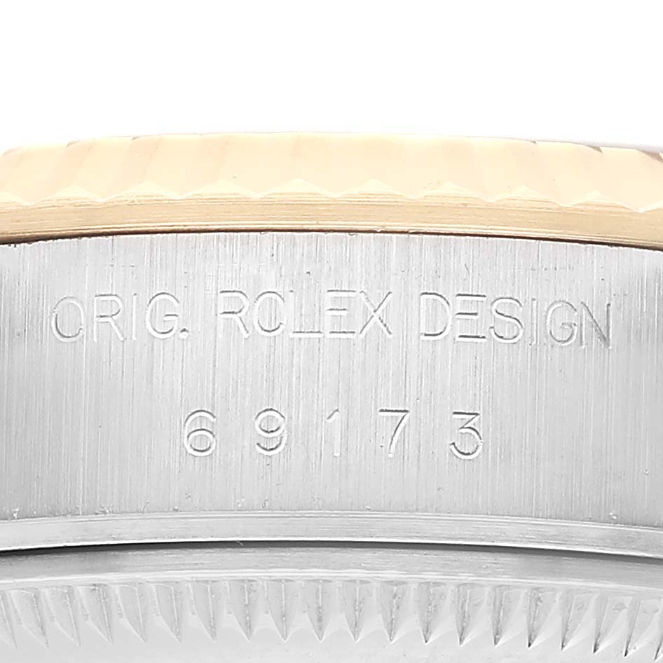 The image shows a close-up of the side of a Rolex Datejust 69173 Women's Steel and Gold (two tone) White Dial, featuring the model number engraving.