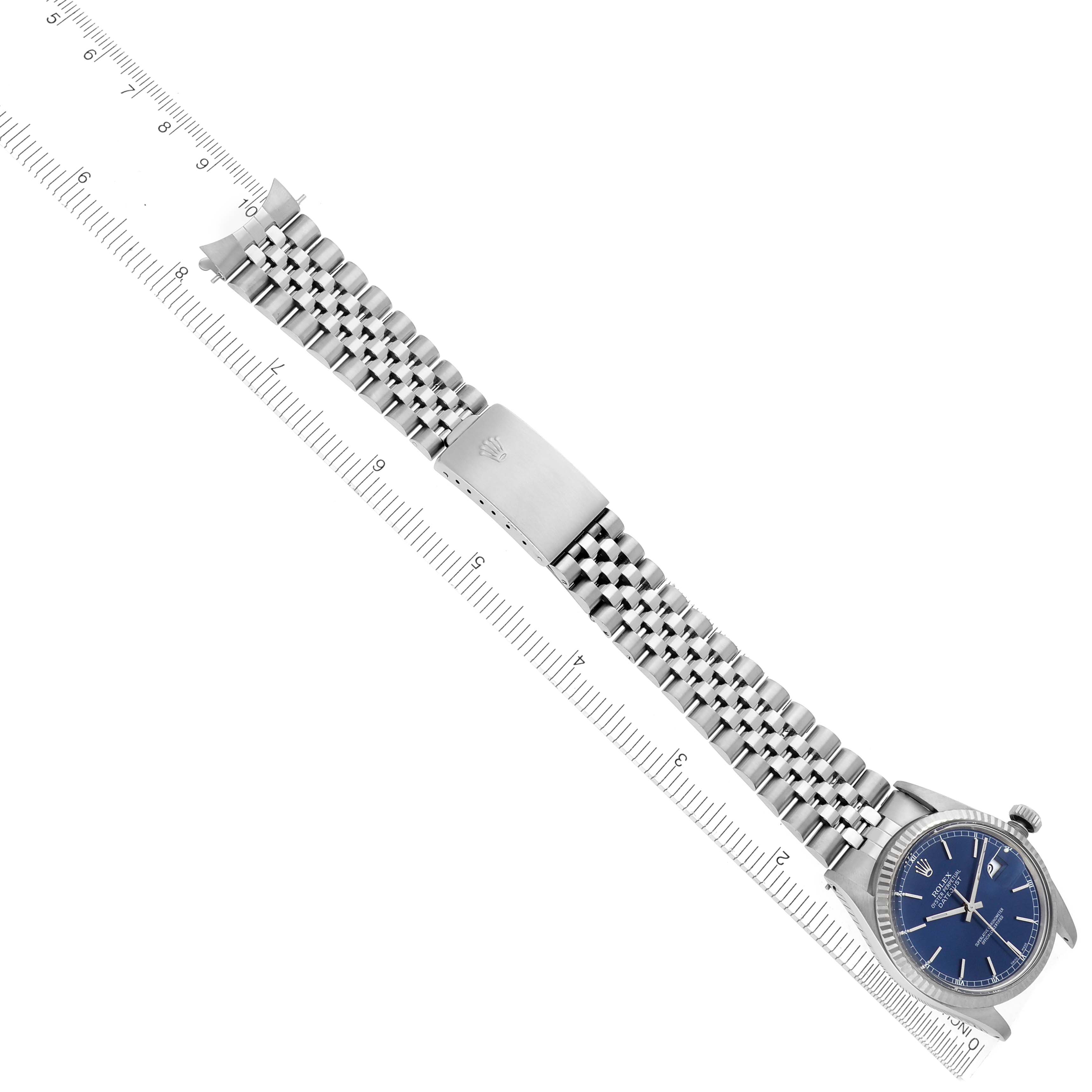 The Rolex Datejust 16014 Men's Stainless Steel Blue Dial 16014 Men's Stainless Steel Blue Dial watch is shown diagonally, featuring a blue dial, stainless steel case, jubilee bracelet, and deployment clasp.