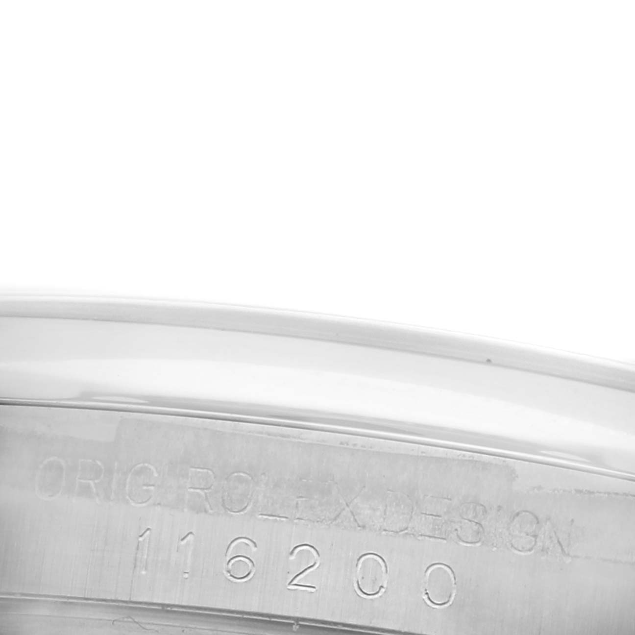 The image shows a close-up of the serial number engraving on the side of the Rolex Datejust 116200 Men's Stainless Steel White Dial 116200 Men's Stainless Steel White Dial watch case.