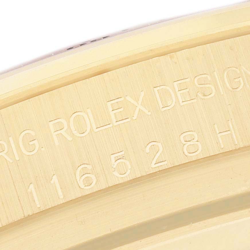 The image shows a close-up of the engraved side of a Rolex Daytona 116528 Men's Yellow Gold Champagne Dial 116528 Men's Yellow Gold Champagne Dial watch, focusing on the model number and design details.