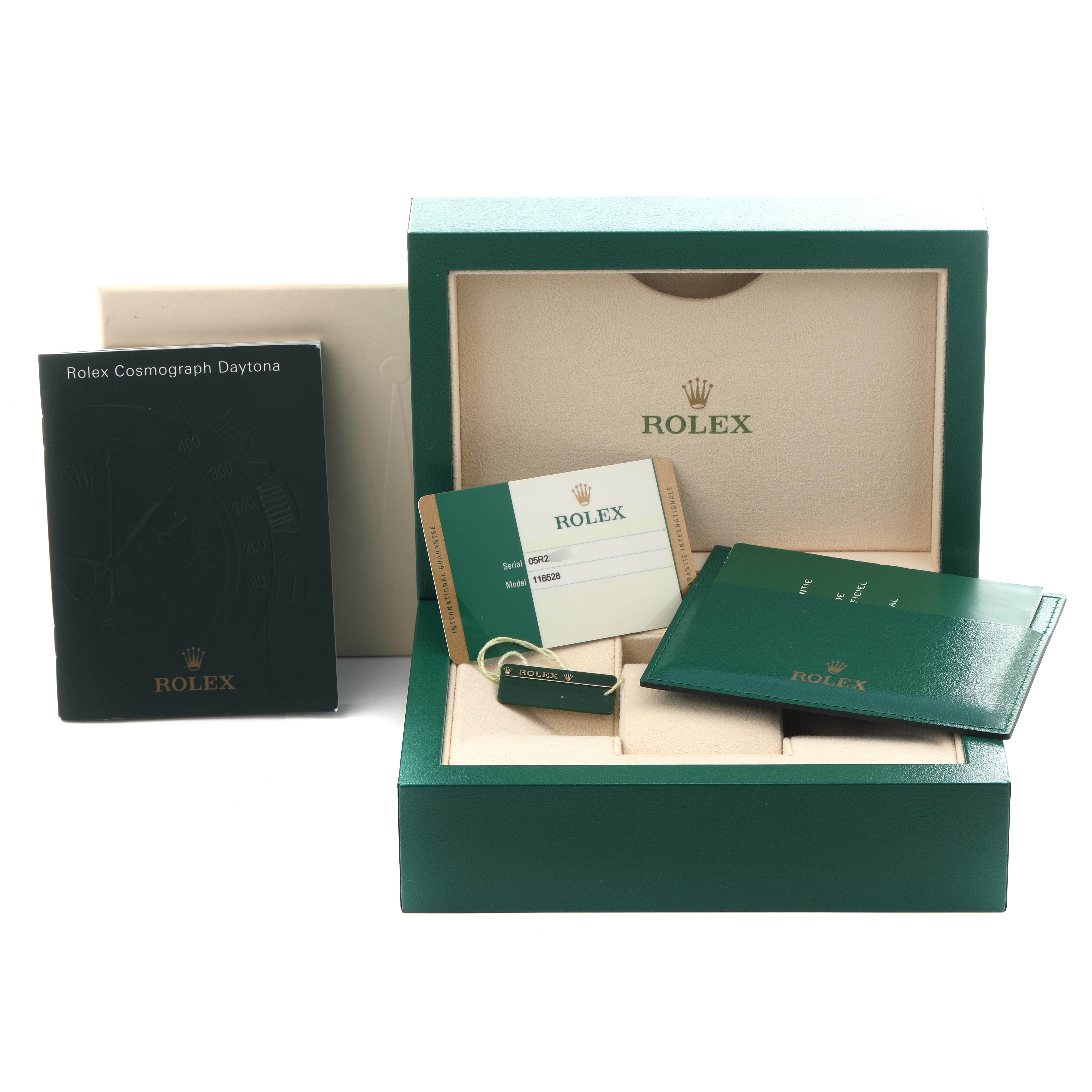 The image shows accessories for a Rolex Daytona 116528 Men's Yellow Gold Champagne Dial 116528 Men's Yellow Gold Champagne Dial watch, including the box, cards, booklet, and tag.