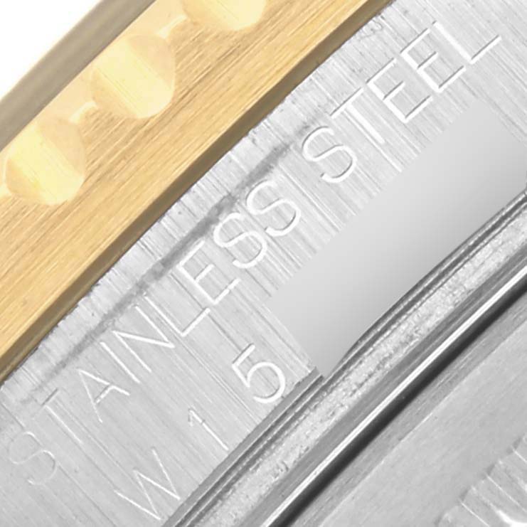 The image shows a close-up of the Rolex GMT-Master 16713 Men's Steel and Gold (two tone) Black Dial 16713 Men's Steel and Gold (two tone) Black Dial's side, highlighting the "STAINLESS STEEL" engraving and the gold bezel edge.