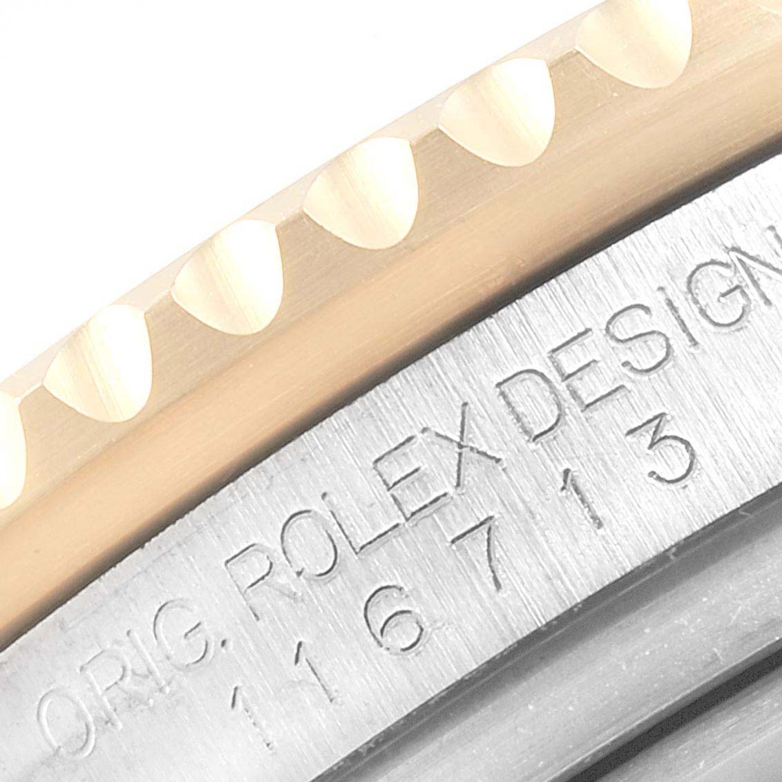 This image shows a close-up of the bezel and case with engraved model number of a Rolex GMT-Master 116713 Men's Steel and Gold (two tone) Black Dial 116713 Men's Steel and Gold (two tone) Black Dial watch.