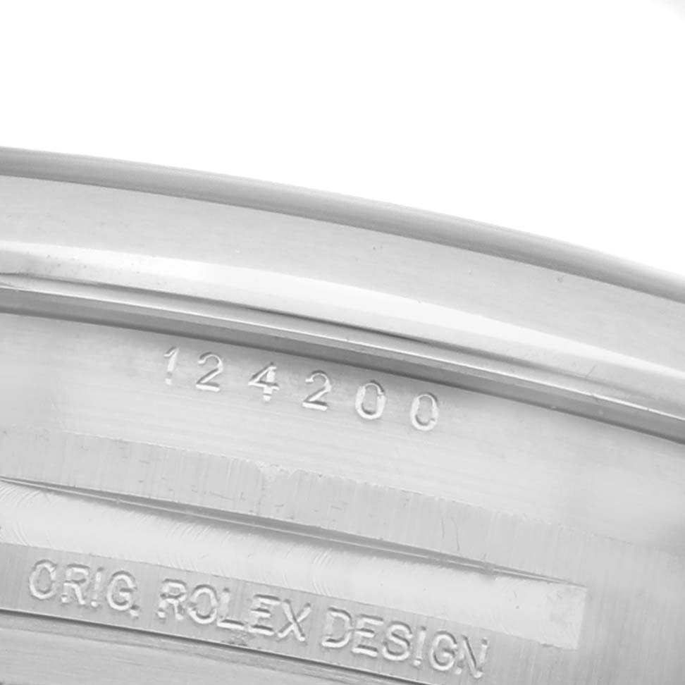 The image shows the side view of the inner casing of a Rolex Oyster Perpetual 124200 Men's Stainless Steel Pink Dial 124200 Men's Stainless Steel Pink Dial, displaying the model number and "ORIG. ROLEX DESIGN" engraving.