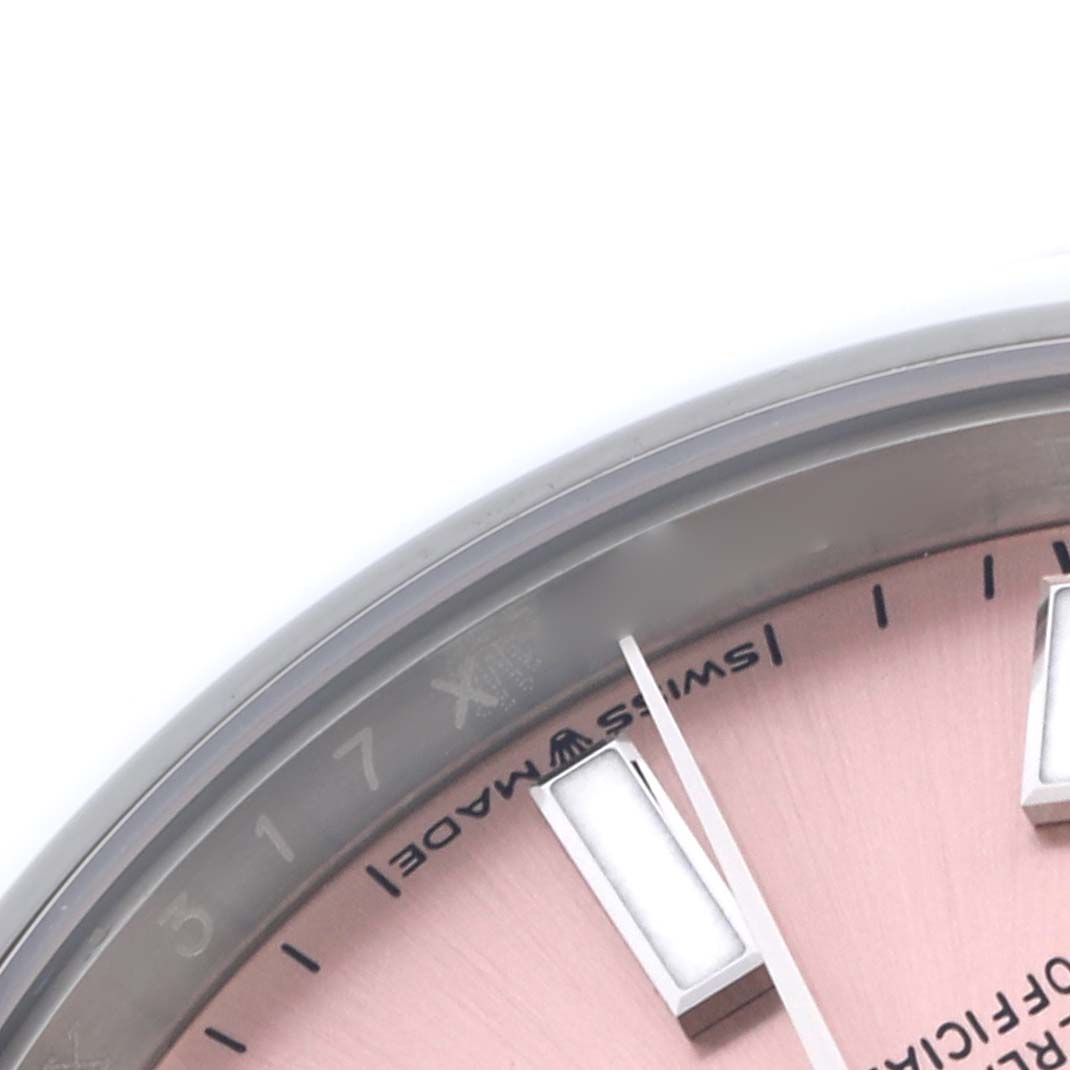 The image shows a close-up of the dial and hands of a Rolex Oyster Perpetual 124200 Men's Stainless Steel Pink Dial 124200 Men's Stainless Steel Pink Dial watch at an angle, highlighting the indices and part of the text.