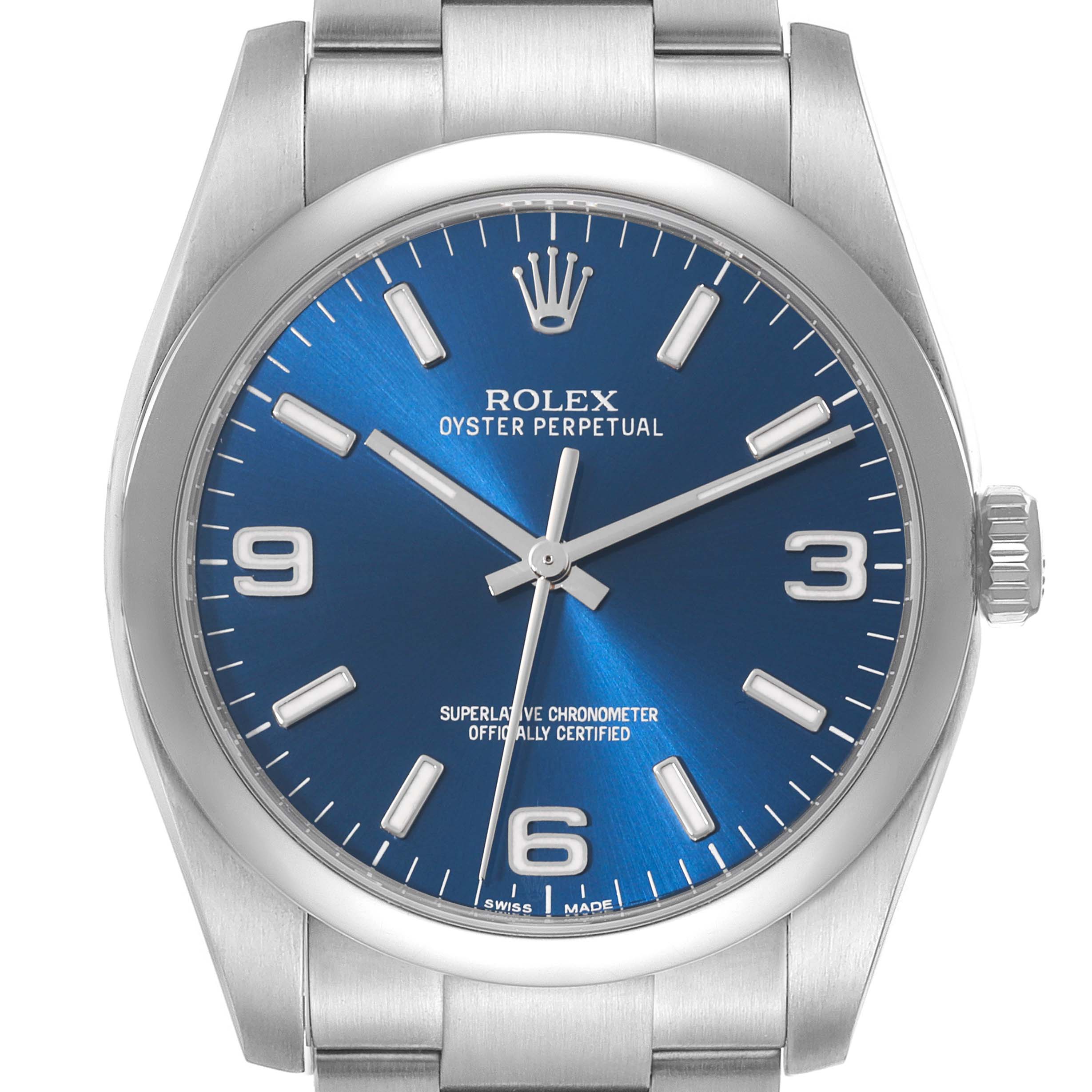 The image shows a front view of a Rolex Oyster Perpetual 116000 Men
s Stainless Steel Blue Dial 116000 Men
s Stainless Steel Blue Dial watch, highlighting its blue dial, hour markers, and stainless steel bracelet.