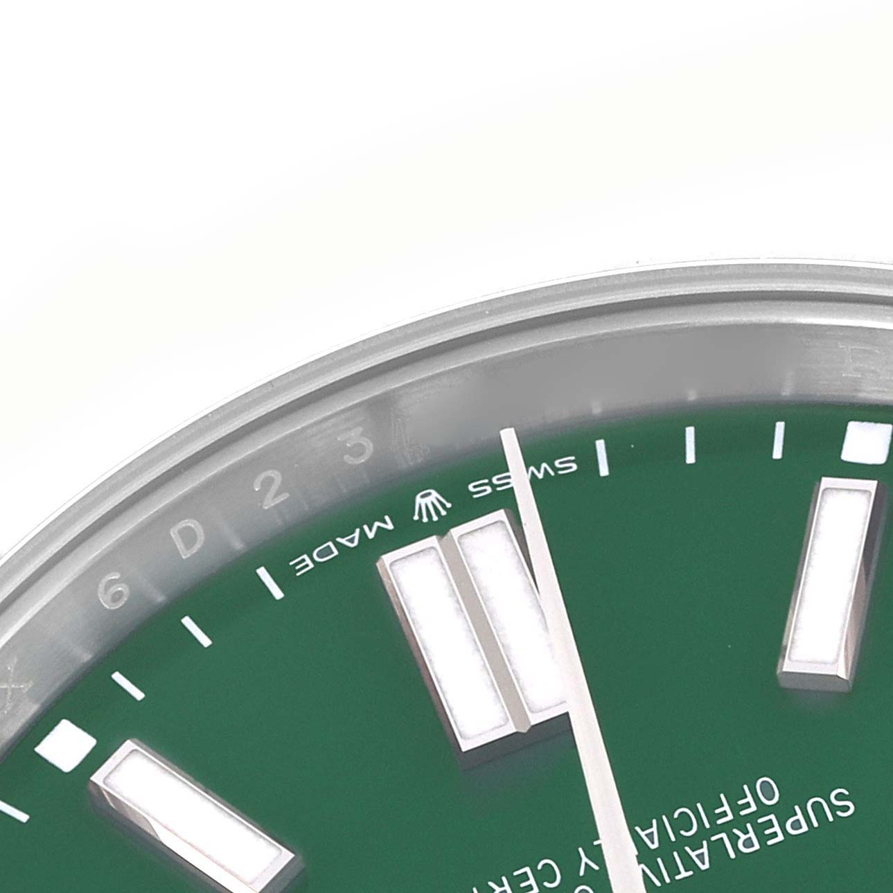 The image shows a close-up of the green dial and markers of a Rolex Oyster Perpetual 124300 Men's Stainless Steel Green Dial 124300 Men's Stainless Steel Green Dial watch.