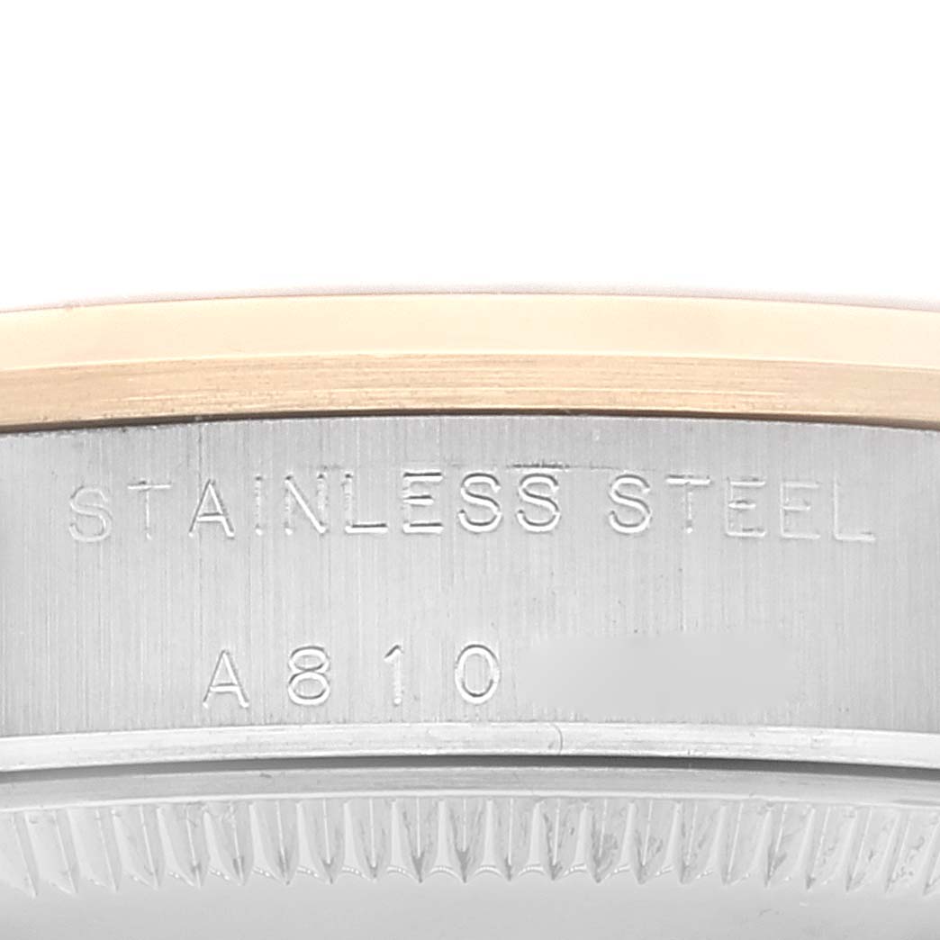 This image shows a close-up of the side of a stainless steel Rolex Mid-Size 77483 Women
s Steel and Gold (two tone) Grey Dial 77483 Women
s Steel and Gold (two tone) Grey Dial model watch, highlighting the engraved text and bezel.