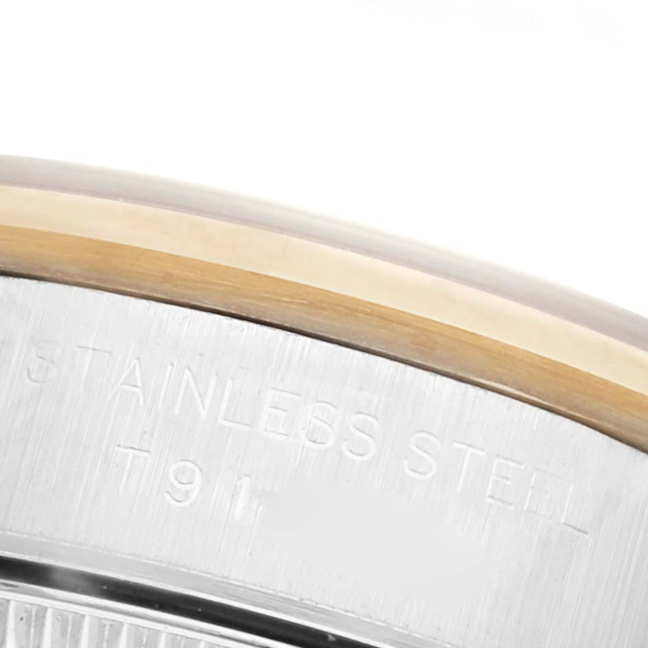 The image shows a close-up of the case back edge of a Rolex Oyster Perpetual 67183 Women's Steel and Gold (two tone) Grey Dial 67183 Women's Steel and Gold (two tone) Grey Dial watch, highlighting the stainless steel engraving.