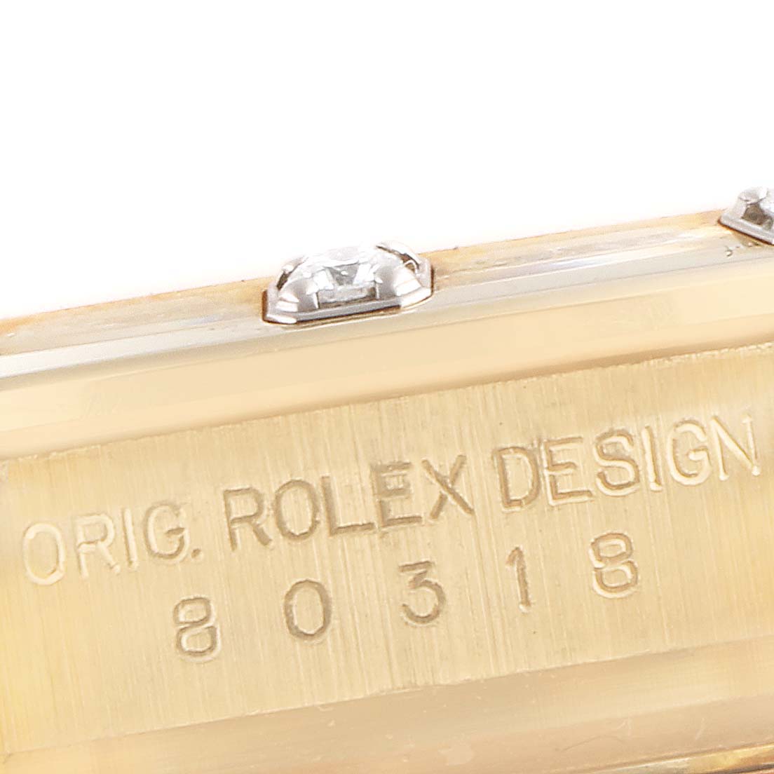 The image shows a close-up angle of the Rolex Pearlmaster 80318 Women's Yellow Gold Champagne Dial 80318 Women's Yellow Gold Champagne Dial's side, highlighting the model number "80318" and design engraving.