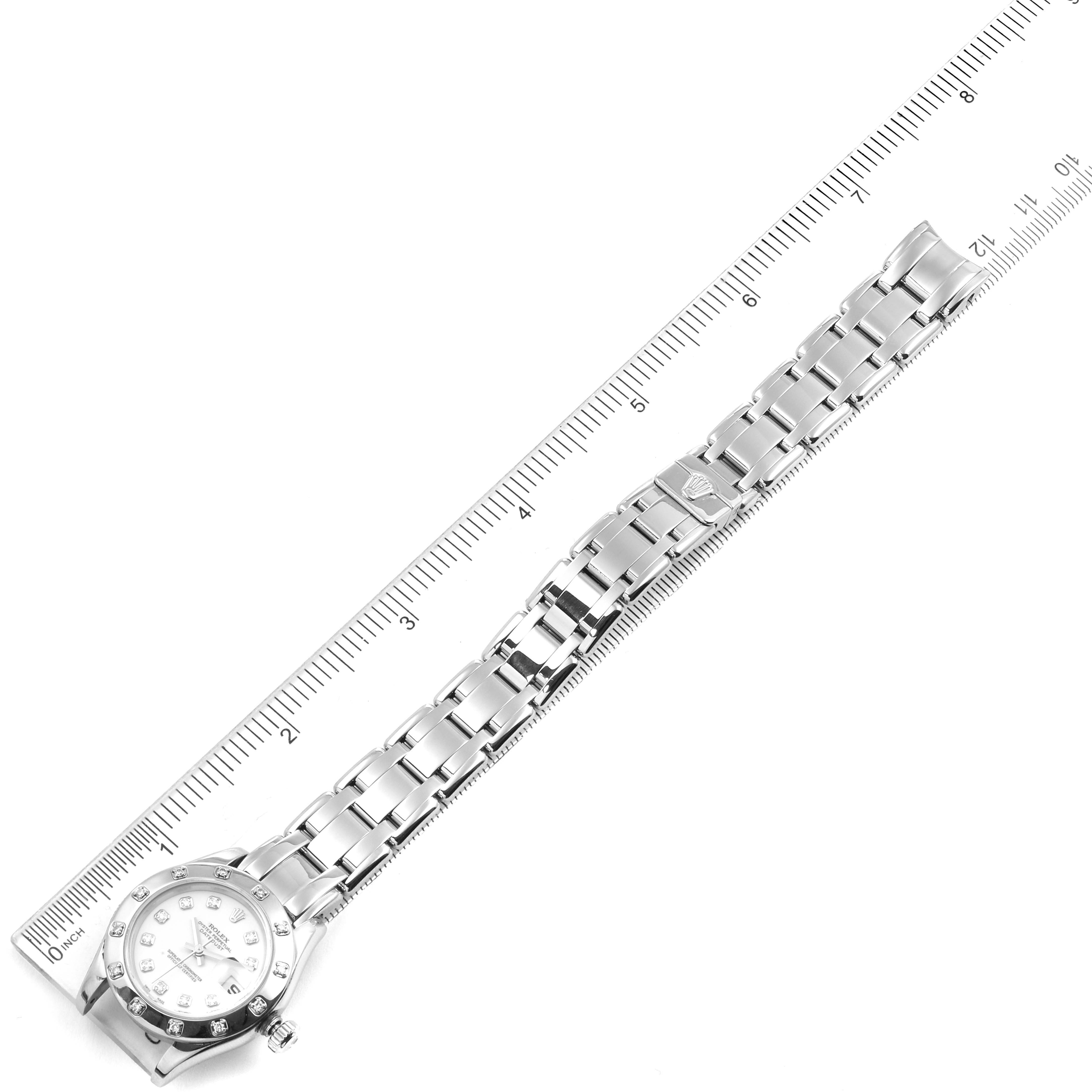 The image shows a top-down view of a Rolex Pearlmaster 80319 Women's White Gold White Dial 80319 Women's White Gold White Dial watch, including its face and full bracelet, next to a ruler for scale.