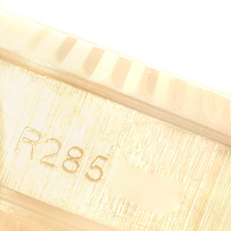 This close-up image shows the serial number engraving on the case of a Rolex President 69178 Women
s Yellow Gold White Dial 69178 Women
s Yellow Gold White Dial model watch.