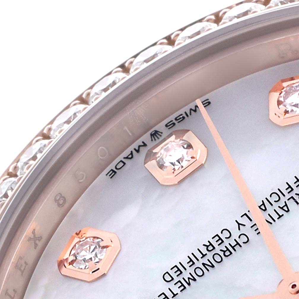 The image shows a close-up of a Mid-Size Rolex, highlighting the diamond bezel, index markers, and part of the dial.