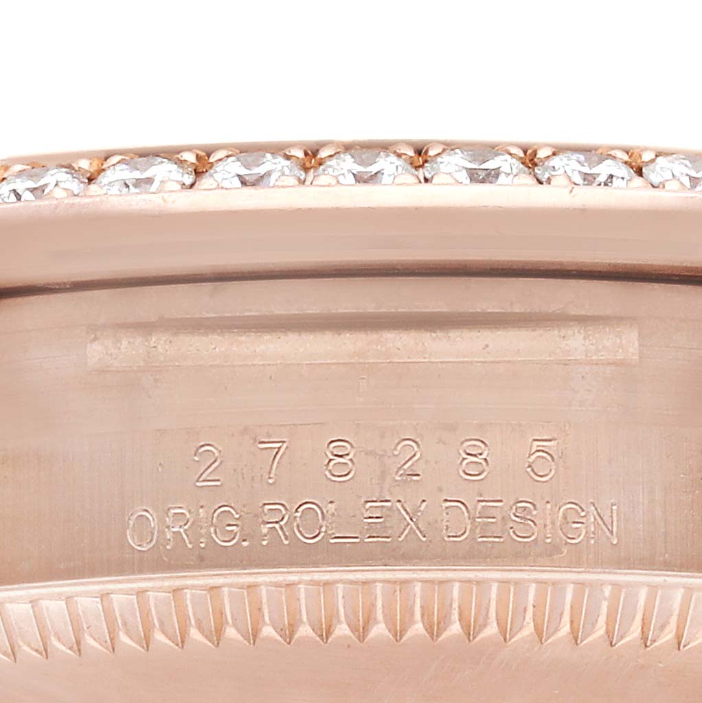 This image focuses on the edge view of a Rolex Mid-Size model, highlighting the serial number and bejeweled bezel.