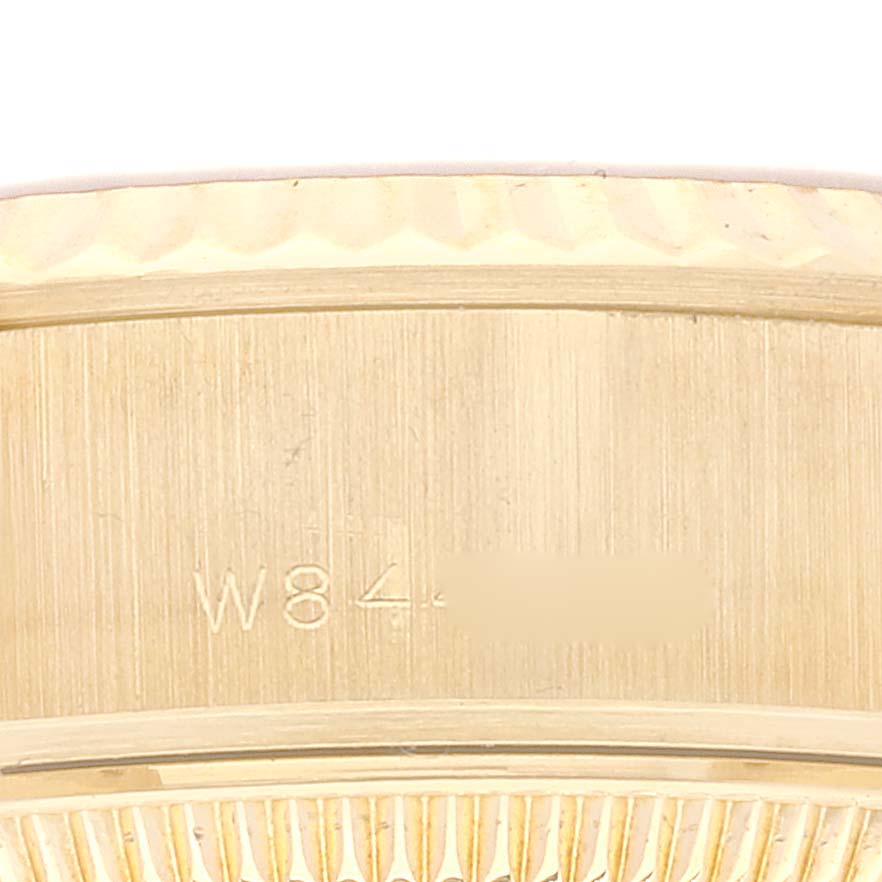 This image shows a close-up of the side of a Rolex President 69178 Women
s Yellow Gold Champagne Dial 69178 Women
s Yellow Gold Champagne Dial model watch, focusing on the serial number engraving.