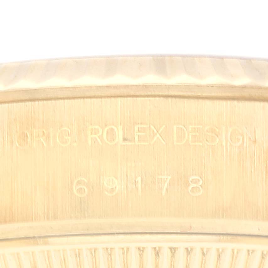 The image shows an angled view of the side of a Rolex President 69178 Women
s Yellow Gold Champagne Dial 69178 Women
s Yellow Gold Champagne Dial model, featuring its original design engraving and model number 69178.
