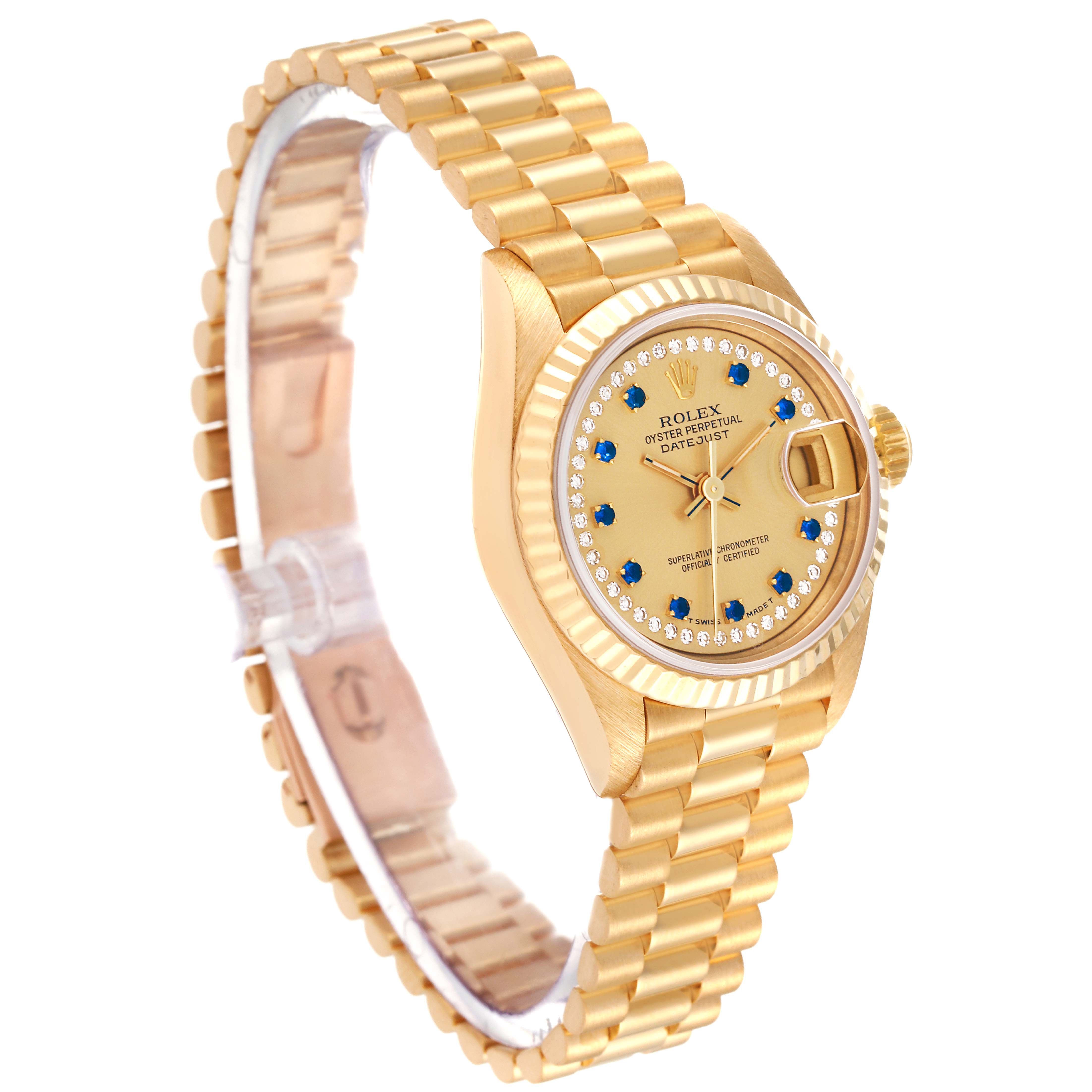 This image shows a side-top angle of the Rolex President 69178 Women
s Yellow Gold Champagne Dial 69178 Women
s Yellow Gold Champagne Dial watch, highlighting its gold bracelet, bezel, and face adorned with blue and diamond markers.