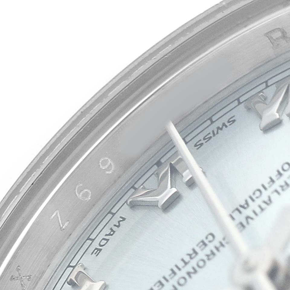 The image shows a close-up of the Rolex President 179166 Women's Platinum Blue Dial watch's dial and bezel, highlighting the roman numerals and engravings.