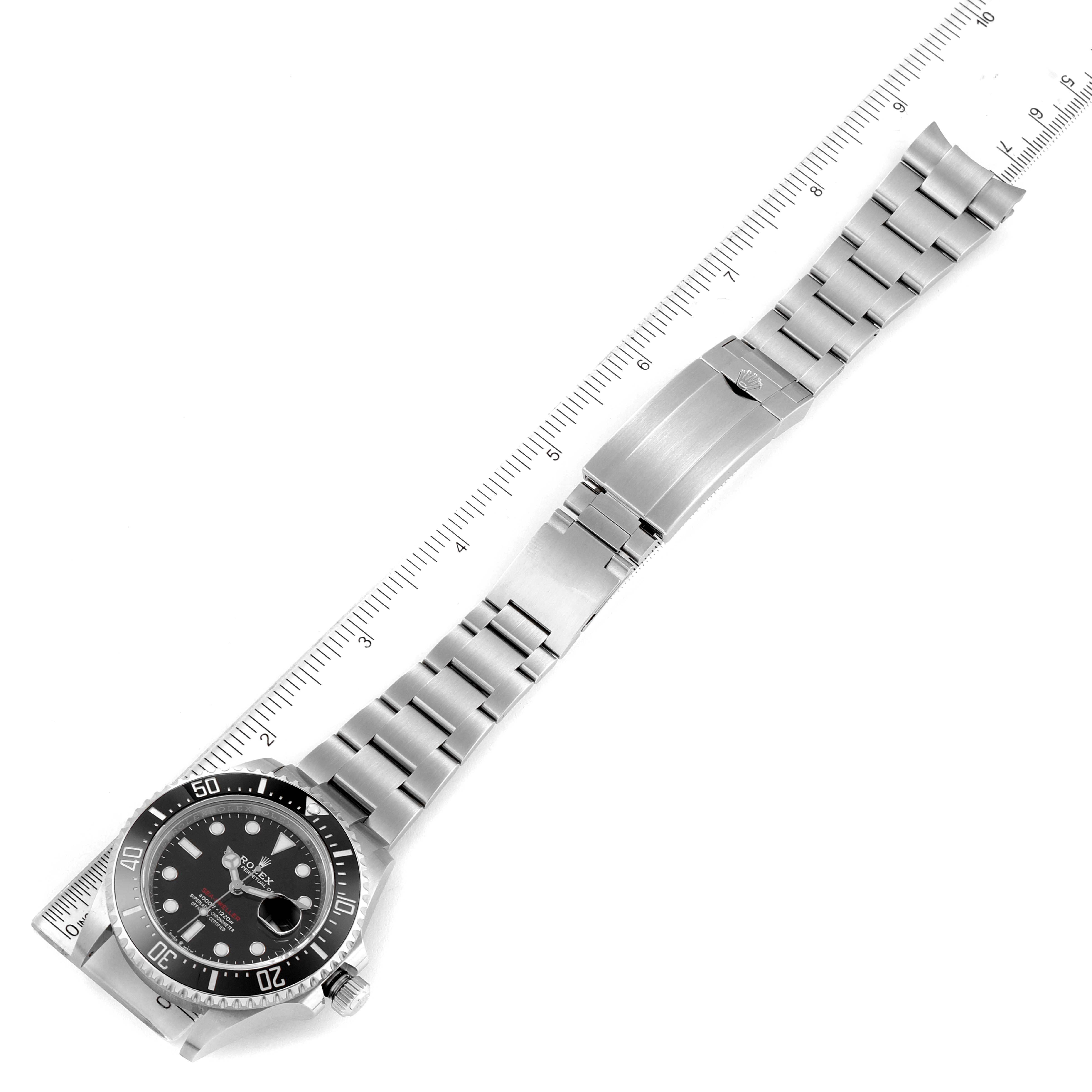 The image shows a top-down view of a Rolex Sea-Dweller 126600 Men's Stainless Steel Black Dial 126600 Men's Stainless Steel Black Dial watch, displaying the entire face, bracelet, and clasp with a ruler for scale.