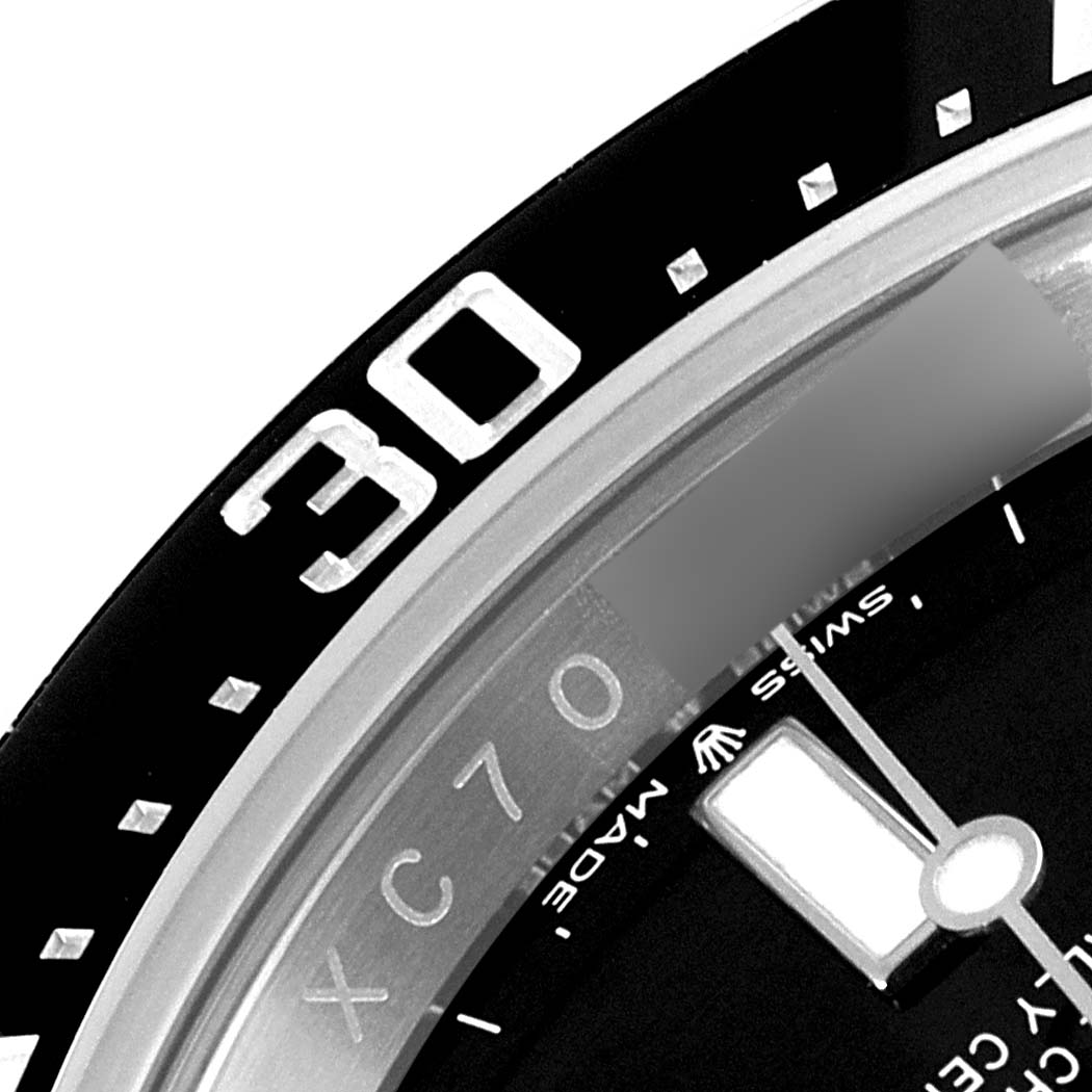 This close-up image of the Rolex Sea-Dweller 126600 Men's Stainless Steel Black Dial 126600 Men's Stainless Steel Black Dial watch shows the bezel with the 30-minute marker and part of the watch face.