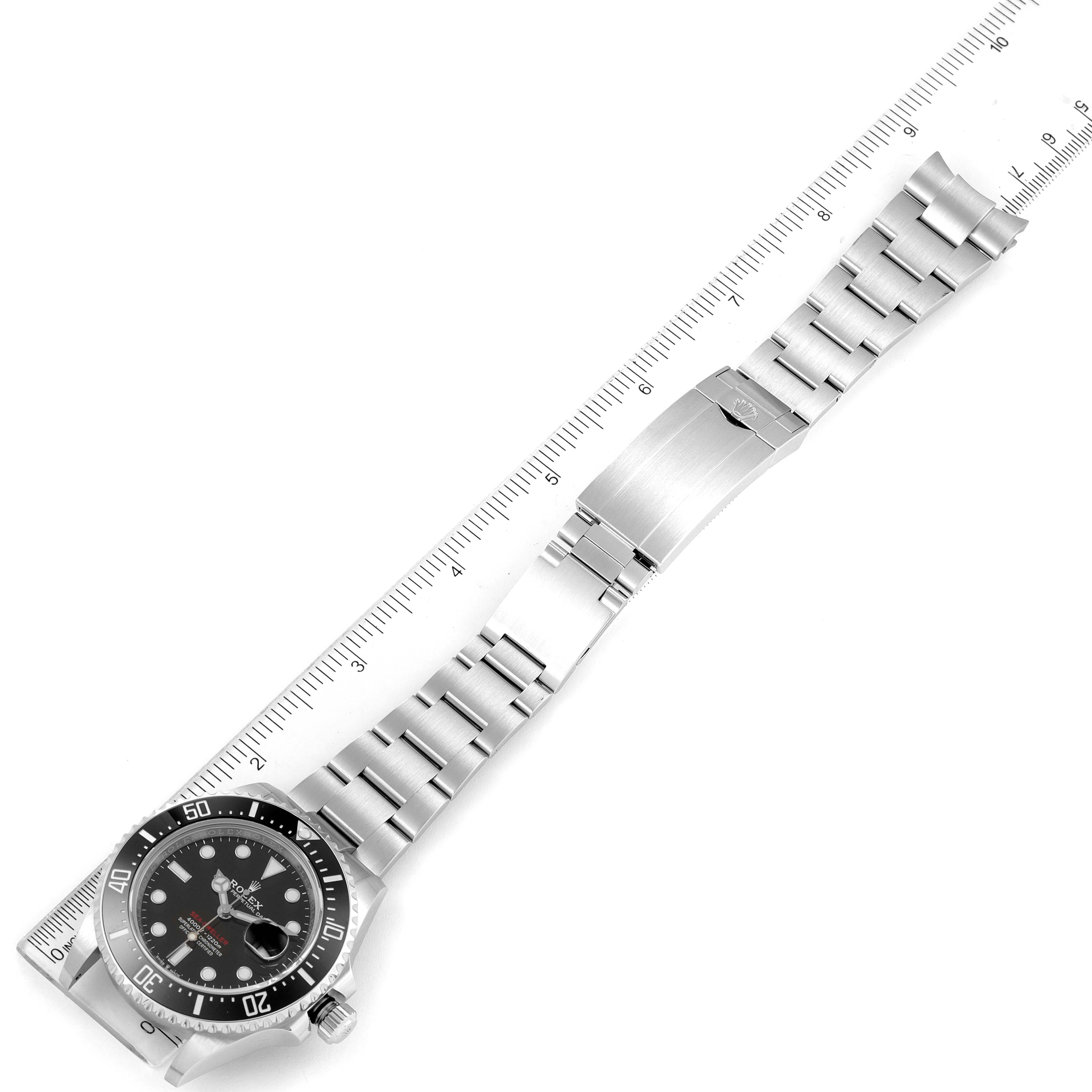 The image displays a top-down view of a Rolex Sea-Dweller 126600 Men's Stainless Steel Black Dial 126600 Men's Stainless Steel Black Dial watch with its bracelet fully extended alongside a ruler for scale.