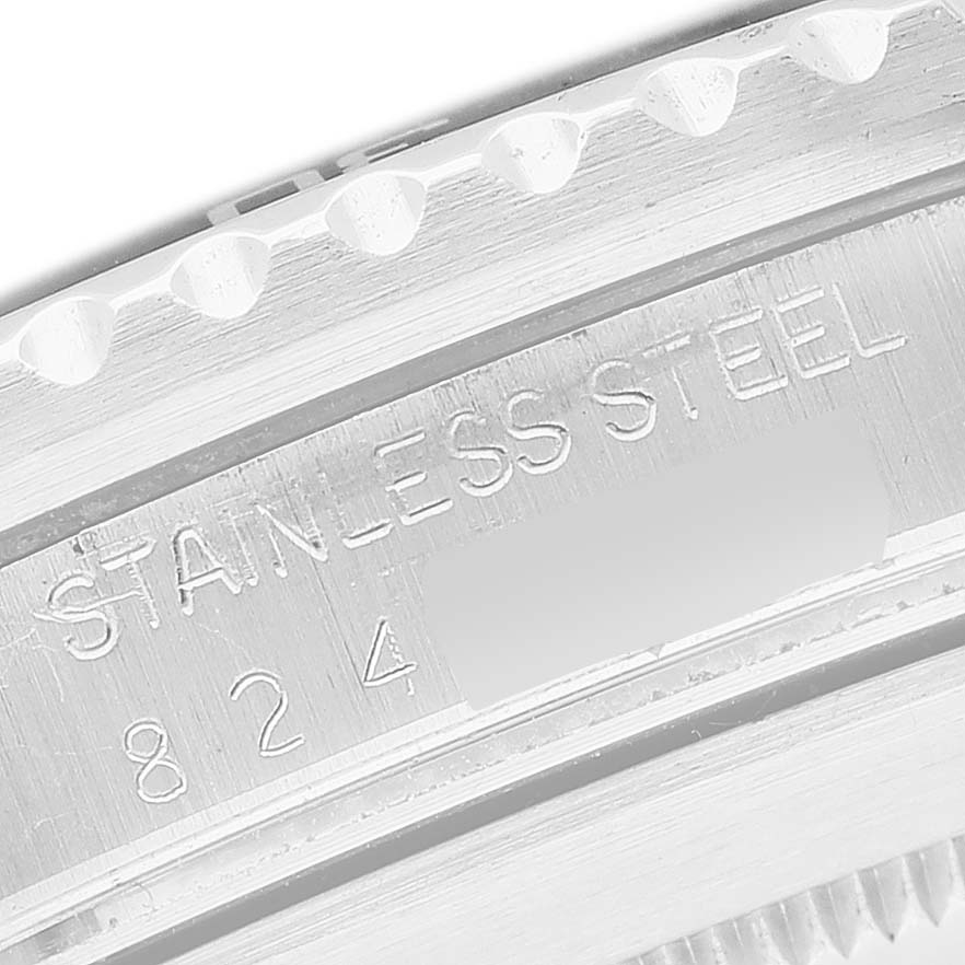 The image shows a close-up of the Rolex Submariner 168000 Men's Stainless Steel Black Dial's stainless steel case with a focus on the engraved text.