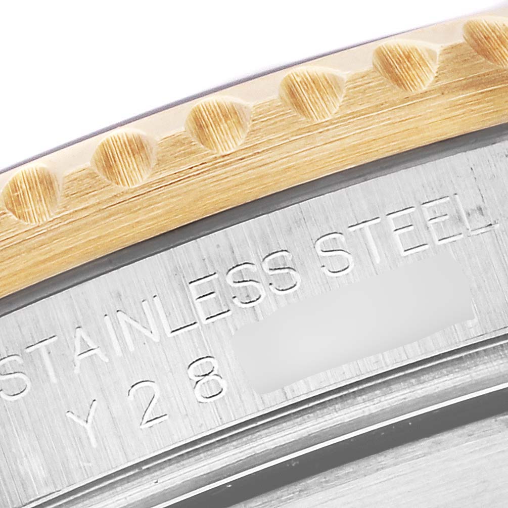 This close-up image shows the stainless steel and gold bezel of a Rolex Submariner 16613 Men
s Steel and Gold (two tone) Blue Dial 16613 Men
s Steel and Gold (two tone) Blue Dial watch.