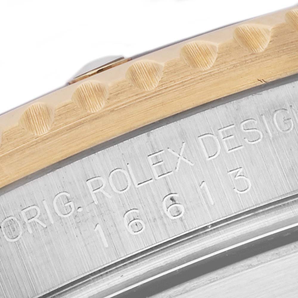 This close-up image shows the case back of a Rolex Submariner 16613 Men
s Steel and Gold (two tone) Blue Dial 16613 Men
s Steel and Gold (two tone) Blue Dial, displaying the model number and "Orig. Rolex Design" engraving.