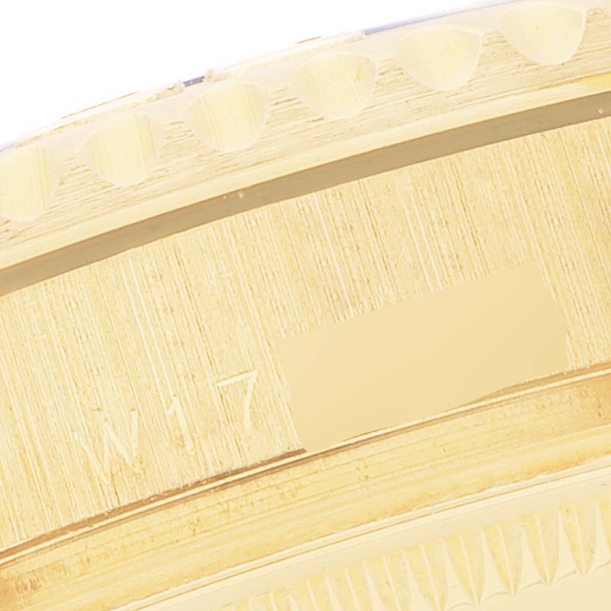 The image shows a close-up of the edge and engravings on the bezel of a Rolex Yacht-Master 68628 Men's Yellow Gold Blue Dial 68628 Men's Yellow Gold Blue Dial watch.
