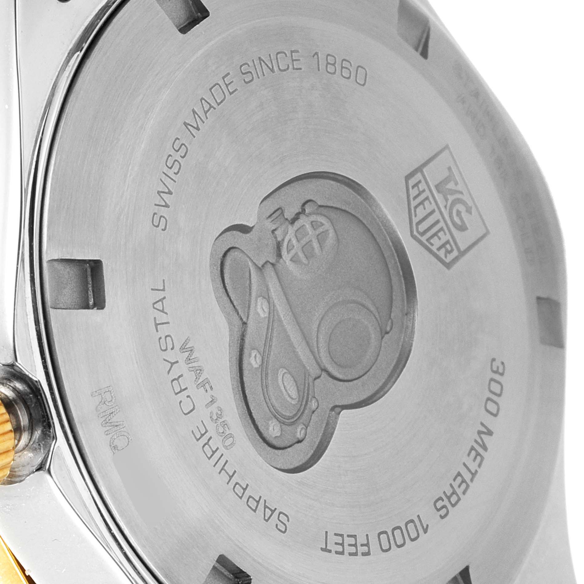 The image shows the underside case back of a Tag Heuer Aquaracer WAF1450.BB0820 Women
s Steel and Gold (two tone) Mother of Pearl Dial WAF1450.BB0820 Women
s Steel and Gold (two tone) Mother of Pearl Dial watch, highlighting engravings and markings.