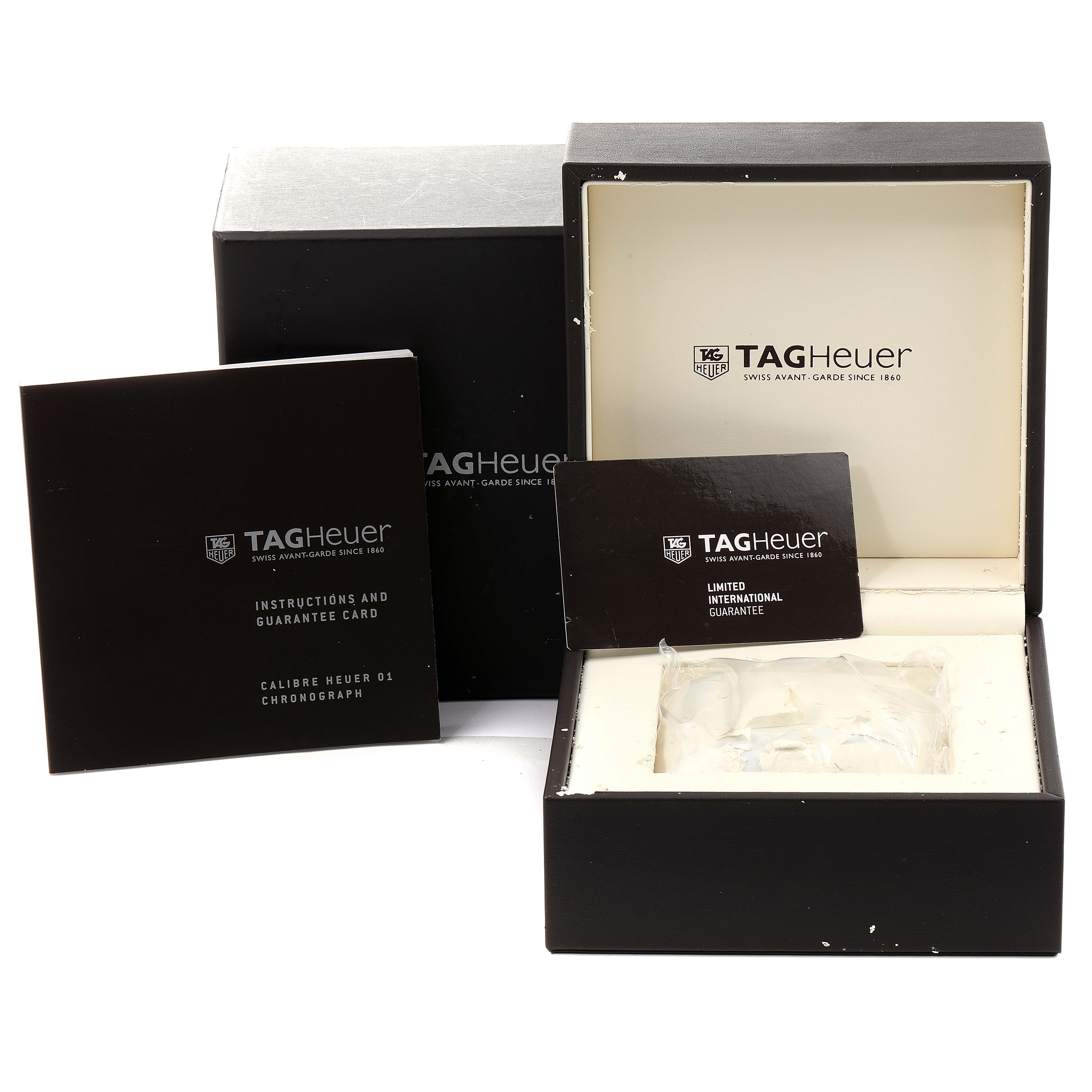 The image shows a box and accessories for a Tag Heuer Carrera CAR201W.BA0714 Men
s Stainless Steel Black Dial CAR201W.BA0714 Men
s Stainless Steel Black Dial watch, including the instruction manual and guarantee card.