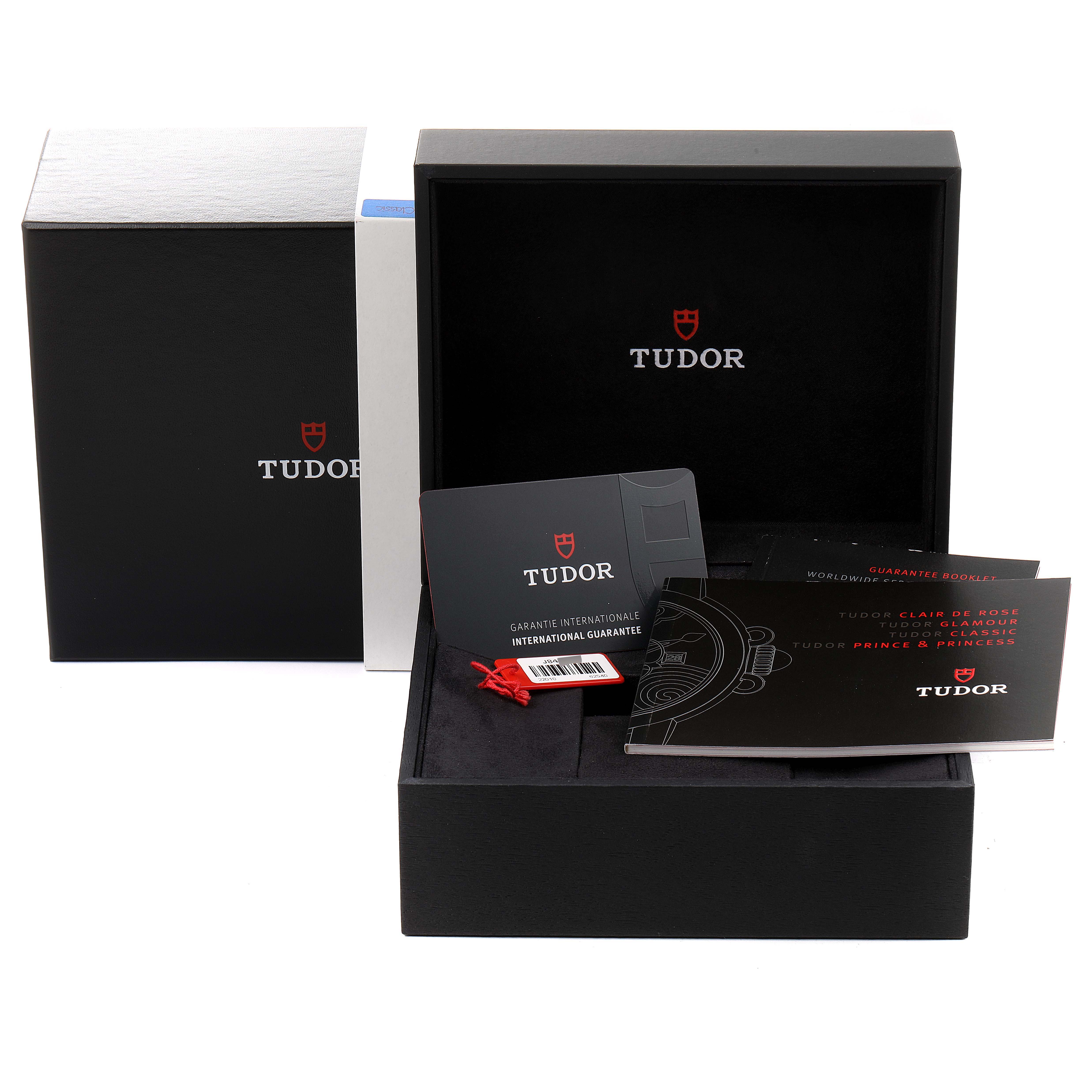 The image shows the packaging, guarantee card, and booklets of the Tudor Classic 22010 Women's Stainless Steel Silver Dial 22010 Women's Stainless Steel Silver Dial watch model.