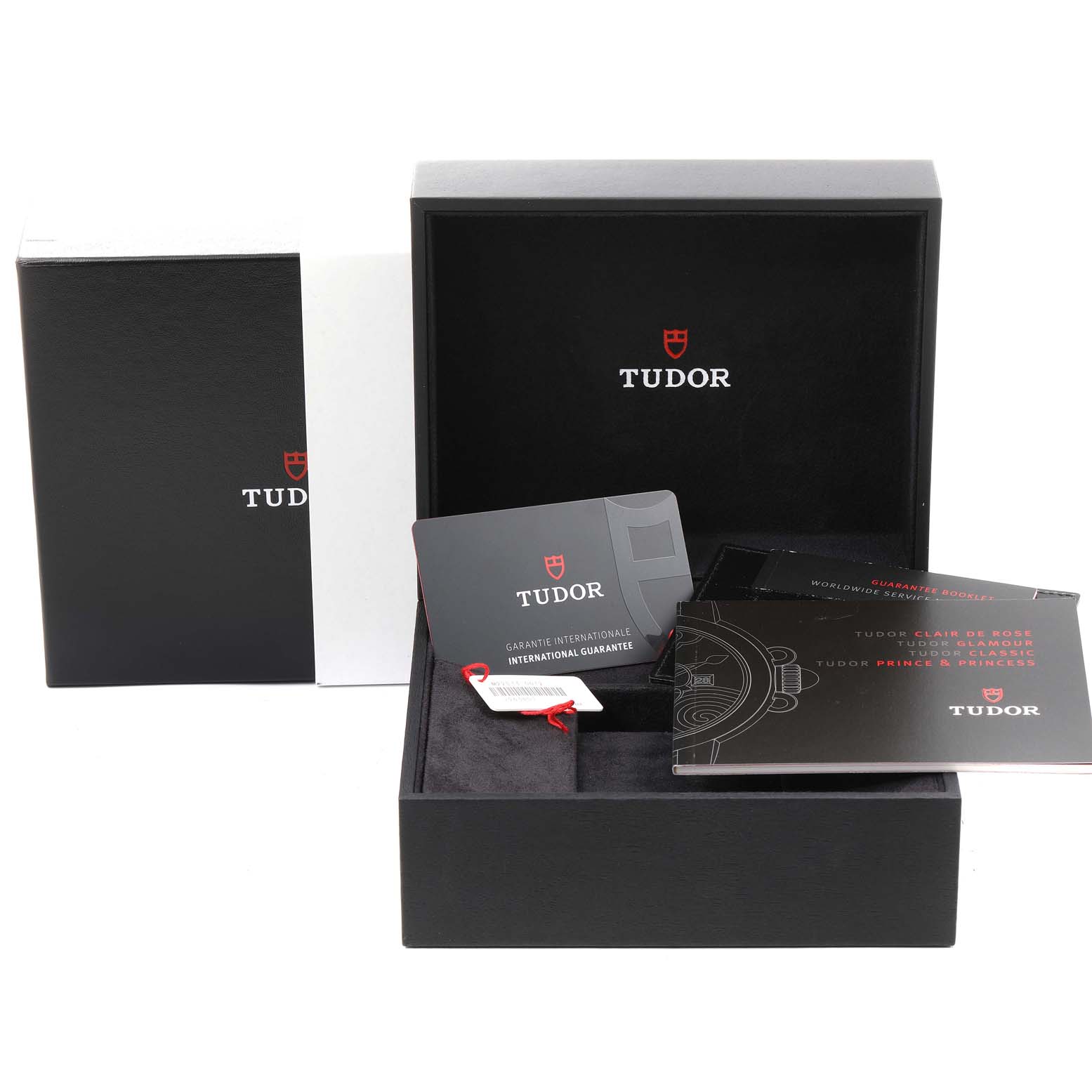 The image shows the packaging, documentation, and warranty card for a Classic model Tudor watch.