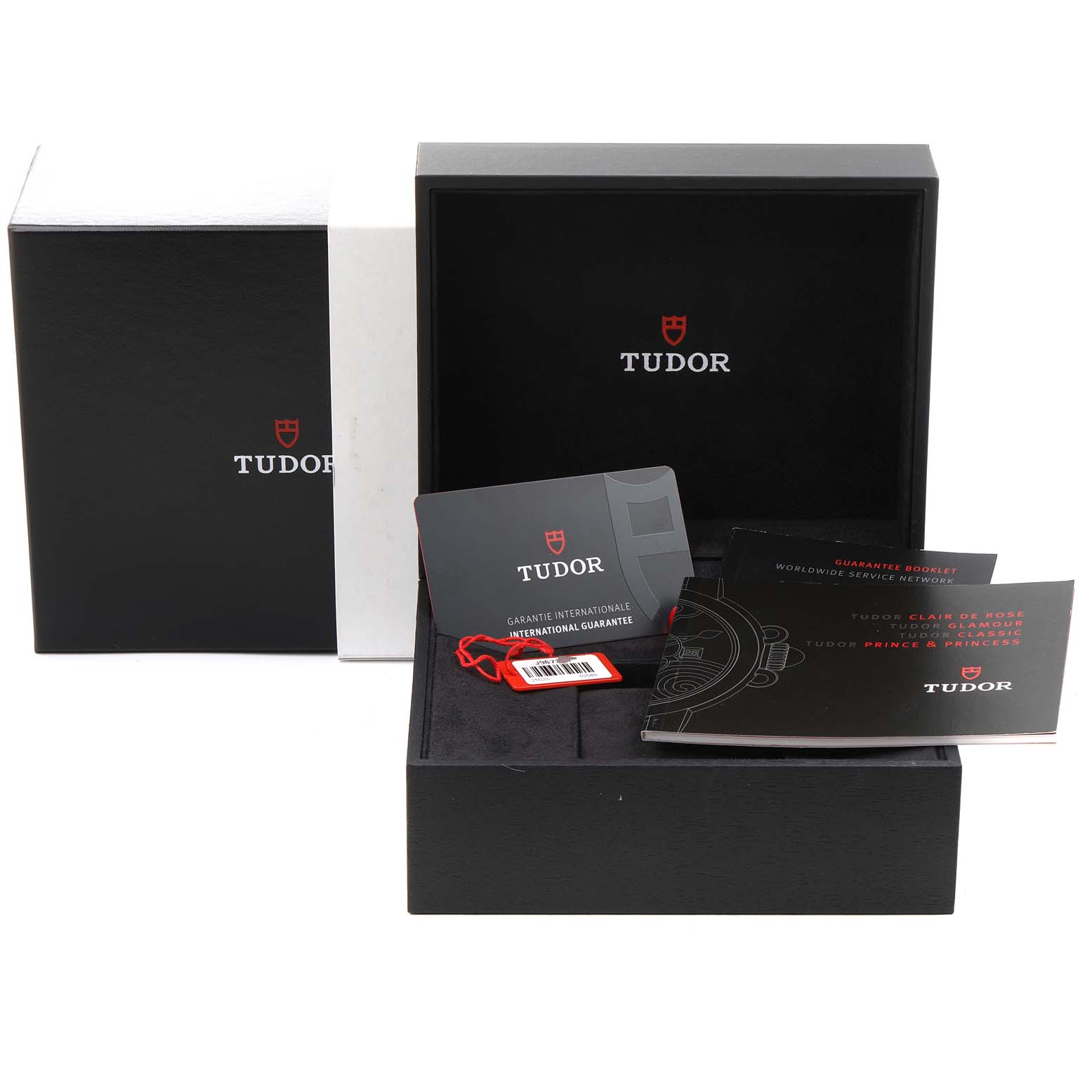 This image shows the packaging, warranty card, and booklets for the Tudor Classic 21023 Men's Steel and Gold (two tone) Black Dial 21023 Men's Steel and Gold (two tone) Black Dial watch model.